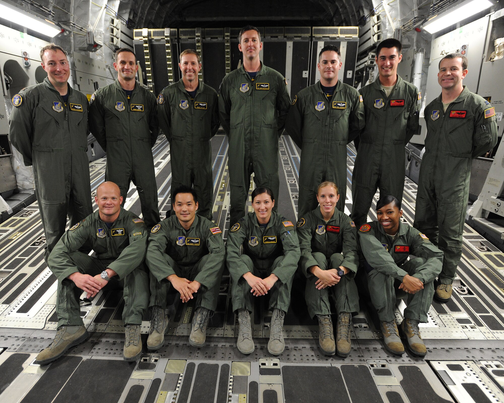 Members of the Pacific Air Forces demonstration team pose for a group photo aboard a C-17 Globemaster III on the flightline at Rimba Air Base during the 4th biennial Brunei Darussalam International Defense Exhibition, Dec. 6, 2013. Joint Base Pearl Harbor-Hickam personnel are showcasing the C-17 Globemaster III in static displays and aerial demonstrations during BRIDEX.  BRIDEX 13 is an opportunity for networking and sharing technology with regional partners and allies which builds strong multilateral relationships, increases cooperation and enhances preparedness for disasters and other contingency operations. (U.S. Air Force photo/Master Sgt. Jerome S. Tayborn)