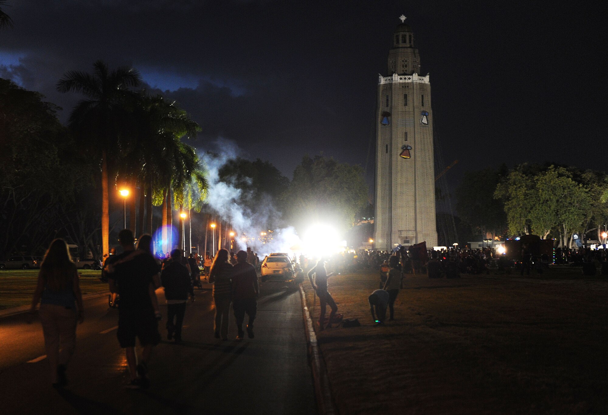 Attendees of the 44th Annual Tower Lighting Celebration arrive at the lighting of Freedom Tower at Joint Base Pearl Harbor-Hickam, Hawaii, Dec. 6, 2013. The celebration included food and entertainment for all ages, including a visit from Santa, arts and crafts, and live band performances from the Hana Hou! Rock Band from the Air Force Band of the Pacific, and singer/ukulele sensation Aidan James.  The highlight of the event was the lighting of the tower by actors Emma Stone and Bill Murray. (U.S. Air Force photo/Staff Sgt. Alex Martinez)
