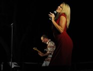 Master Sgt. Lara Murdzia, vocalist with the Hana Hou! Rock Band from the Air Force Band of the Pacific, performs a holiday classic song during the 44th Annual Tower Lighting Celebration at Joint Base Pearl Harbor-Hickam, Hawaii, Dec. 6, 2013. The celebration included food and entertainment for all ages, including a visit from Santa, arts and crafts, and live band performances from Hana Hou! Rock Band and singer/ukulele sensation Aidan James. The highlight of the event was the lighting of Freedom Tower by actors Emma Stone and Bill Murray. (U.S. Air Force photo/Staff Sgt. Alex Martinez)