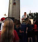 Todd Offutt, the volunteer master of ceremonies for the 44th Annual Tower Lighting Celebration, asks young Hickam members a trivia question during the event at Joint Base Pearl Harbor-Hickam, Hawaii, Dec. 6, 2013. The celebration included food and entertainment for all ages, including a visit from Santa, arts and crafts, live band performances from the Hana Hou! Rock Band from the Air Force Band of the Pacific, and ukulele sensation Aidan James.  The highlight of the event was the lighting of Freedom Tower by actors Emma Stone and Bill Murray. (U.S. Air Force photo/Staff Sgt. Alex Martinez)