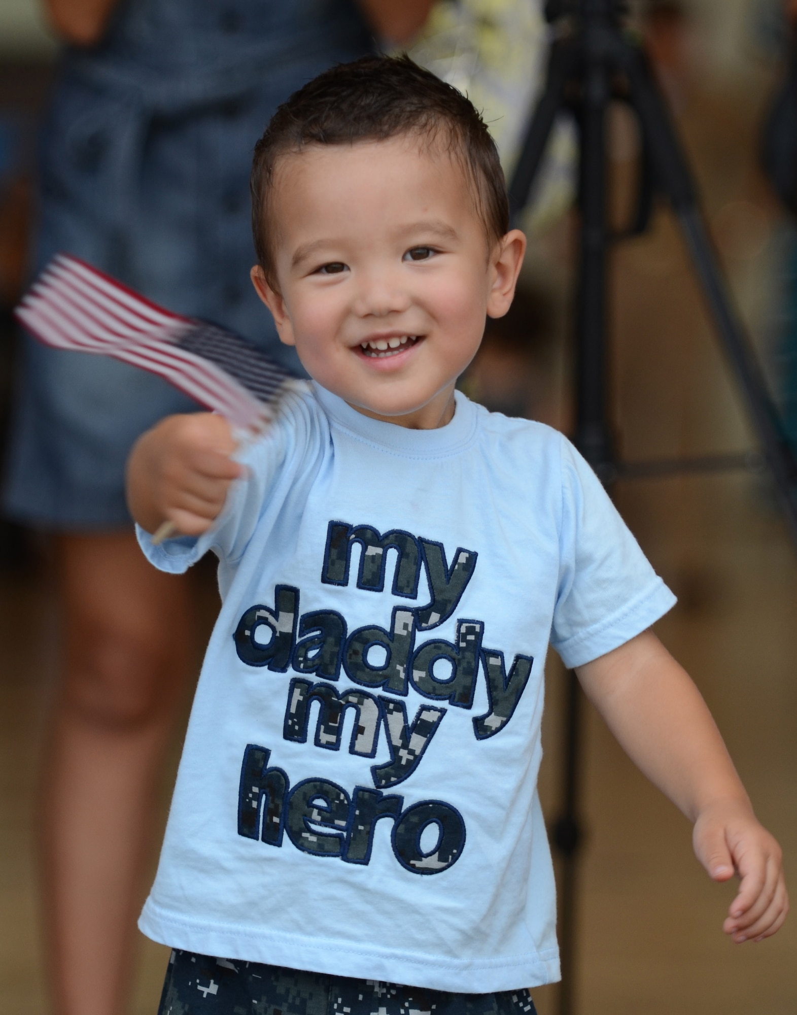 A child waves a U.S. Flag while waiting for his father during the U.S. Navy Helicopter Sea Combat Squadron 25 Detachment 6 homecoming Dec. 9, 2013, on Andersen Air Force Base, Guam. During the unit’s nine-month deployment aboard USS Bonhomme Richard, Det 6 supported the U.S. Navy 7th Fleet in the Western Pacific area of responsibility. (U.S. Air Force photo by Senior Airman Marianique Santos/Released)