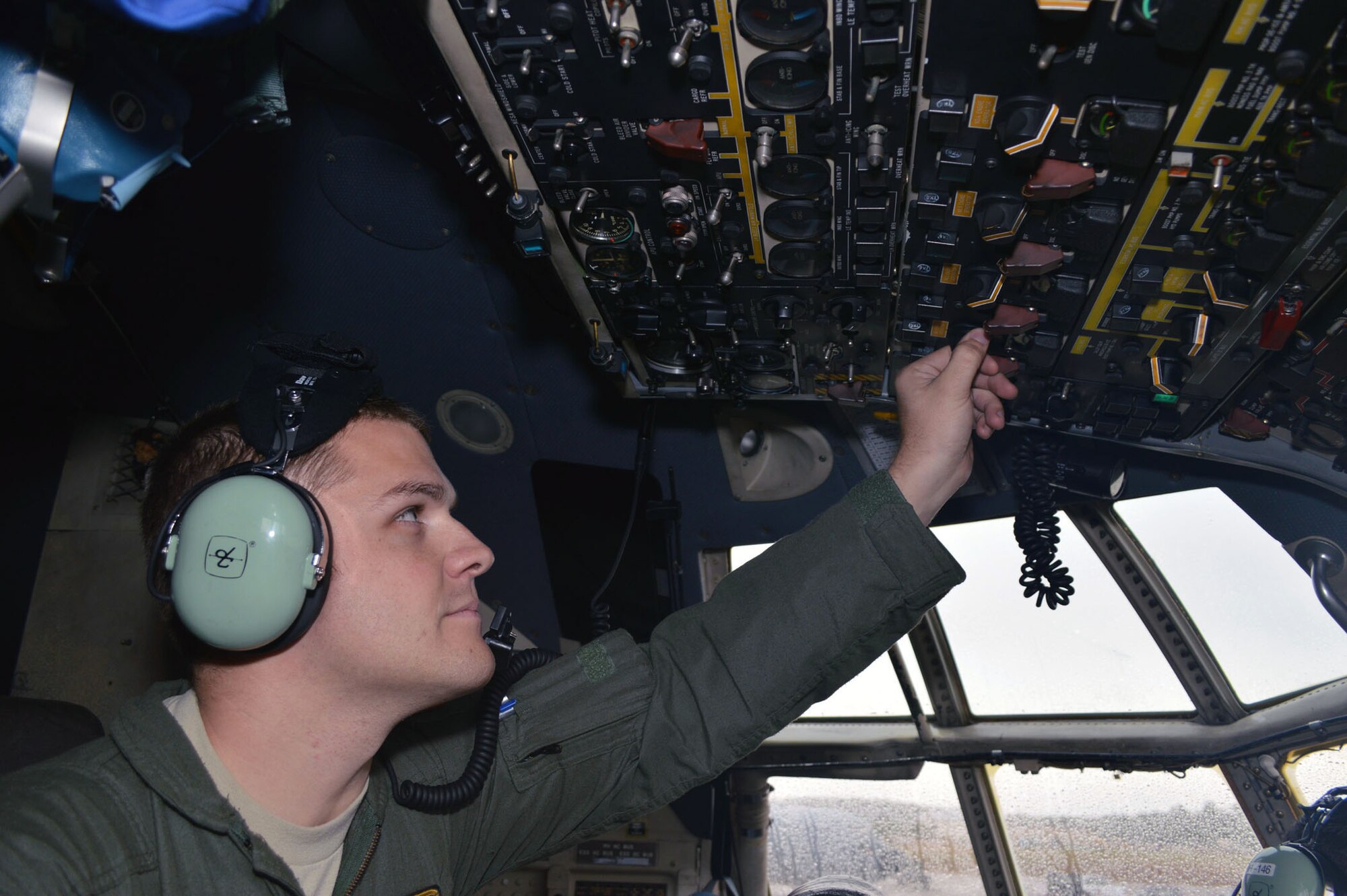 U.S. Air Force Staff Sgt. Jonathan Wright, a C-130H Hercules flight engineer, prepares the aircraft for taxing during Operation Toy Drop 2013, Pope Army Airfield, N.C. on Dec. 7. Operation Toy Drop is an annual U.S. Army Civil Affairs and Psychological Operations Command (Airborne) sponsored event. The main purpose is to gather toys donated by Fort Bragg Soldiers and distribute them to local children who might otherwise not receive a toy for the holidays. A large airborne operation is also part of Operation Toy Drop. Paratroopers will get a chance to train with a jumpmaster from one of nine countries participating this year. This allows them to earn foreign airborne or “jump” wings. (U.S. Air Force photo/Marvin Krause) 