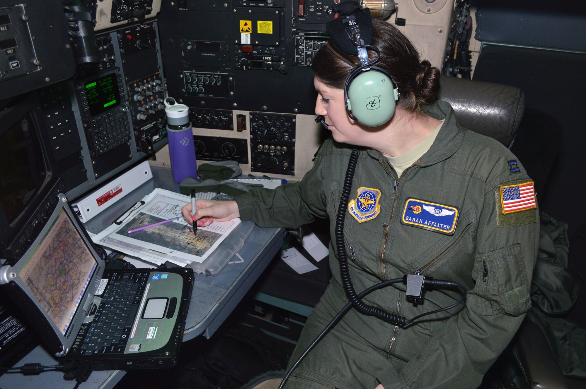 U.S. Air Force Capt. Sarah Affalter, a C-130H Hercules navigator from the 43rd Airlift Group, conducts mission planning during Operation Toy Drop 2013, Pope Army Airfield, N.C. on Dec. 7. Operation Toy Drop is an annual U.S. Army Civil Affairs and Psychological Operations Command (Airborne) sponsored event. The main purpose is to gather toys donated by Fort Bragg Soldiers and distribute them to local children who might otherwise not receive a toy for the holidays. A large airborne operation is also part of Operation Toy Drop. Paratroopers will get a chance to train with a jumpmaster from one of nine countries participating this year. This allows them to earn foreign airborne or “jump” wings. (U.S. Air Force photo/Marvin Krause) 
