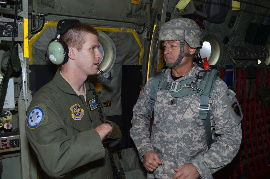U.S. Air Force Senior Airman Sean Magestro, a loadmaster from the 43rd Operations Support Squadron, discusses airdrop mission planning with 1st Sgt. David Kidder, 404th Civil Affairs Battalion (Airborne), Fort Dix, N.J., during Operation Toy Drop 2013, Pope Army Airfield, N.C. on Dec. 7. Operation Toy Drop is an annual U.S. Army Civil Affairs and Psychological Operations Command (Airborne) sponsored event. The main purpose is to gather toys donated by Fort Bragg Soldiers and distribute them to local children who might otherwise not receive a toy for the holidays. A large airborne operation is also part of Operation Toy Drop. Paratroopers will get a chance to train with a jumpmaster from one of nine countries participating this year. This allows them to earn foreign airborne or “jump” wings. (U.S. Air Force photo/Marvin Krause) 