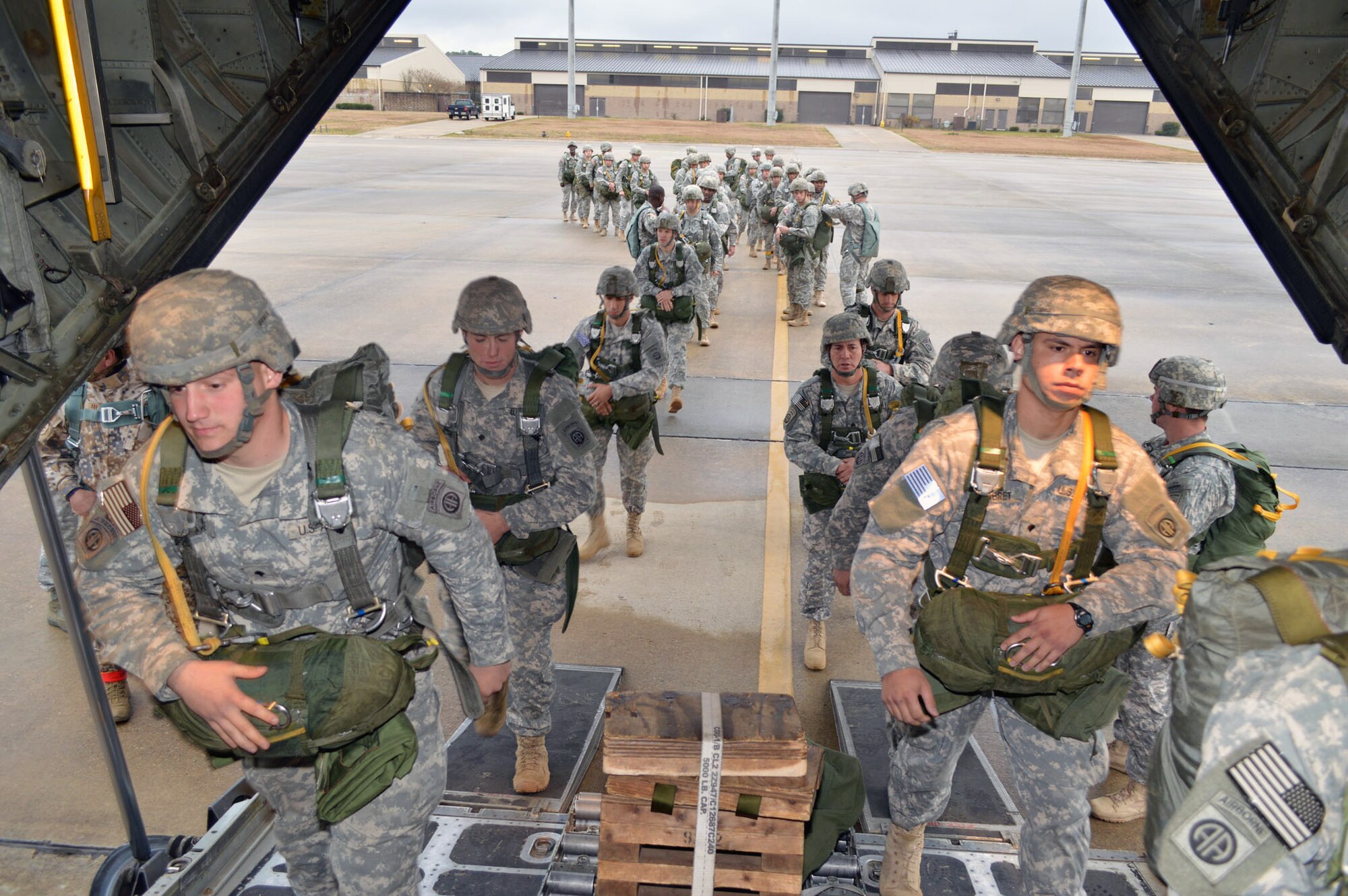 U.S. Army paratroopers from Fort Bragg, N.C. load onto a C-130H Hercules aircraft from the 910th Airlift Wing, Youngstown, Ohio, on Green Ramp during Operation Toy Drop 2013, Pope Army Airfield, N.C. on Dec. 7. Operation Toy Drop is an annual U.S. Army Civil Affairs and Psychological Operations Command (Airborne) sponsored event. The main purpose is to gather toys donated by Fort Bragg Soldiers and distribute them to local children who might otherwise not receive a toy for the holidays. A large airborne operation is also part of Operation Toy Drop. Paratroopers will get a chance to train with a jumpmaster from one of nine countries participating this year. This allows them to earn foreign airborne or “jump” wings. (U.S. Air Force photo/Marvin Krause) 