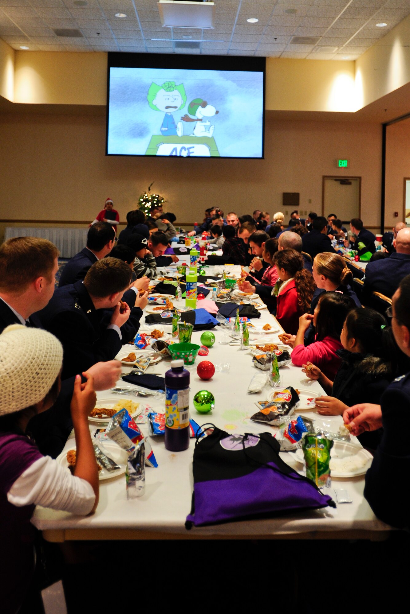 VANDENBERG AIR FORCE BASE, Calif. – Children and their escorts eat lunch during the Operation Kids Christmas event at the Pacific Coast Club here Saturday, Dec. 7, 2013. OKC is an annual event, organized and run by a private organization, in which about 200 local children are brought on base and given the opportunity to play games, meet Santa and enjoy the companionship of volunteer military members (U.S. Air Force photo/ Airman 1st Class Yvonne Morales)
