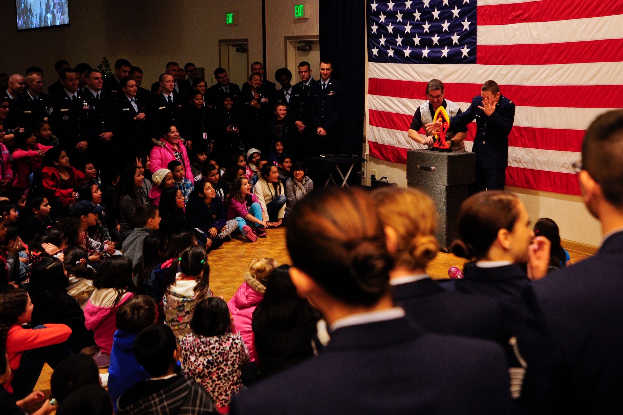 VANDENBERG AIR FORCE BASE, Calif. – Local children and escorts gather for a magician’s act during the Operation Kids Christmas event at the Pacific Coast Club here Saturday, Dec. 7, 2013. OKC is an annual event, organized and run by a private organization, in which about 200 local children are brought on base and given the opportunity to play games, meet Santa and enjoy the companionship of volunteer military members (U.S. Air Force photo/ Airman 1st Class Yvonne Morales)