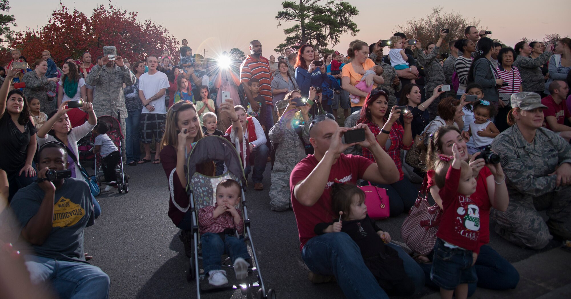 Onlookers gather to see children from Youth Programs perform holiday carols during the Annual Tree Lighting Ceremony and Holiday Parade Dec. 6, 2013, at Moody Air Force Base, Ga. The group preformed three songs to kick off the tree lighting ceremony. (U.S. Air Force photo by Airman 1st Class Sandra Marrero/Released) 
