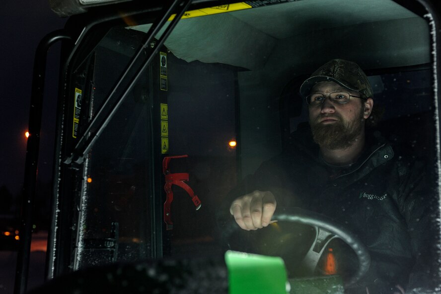 Dustin Moen, a landscaping contractor operates a small snow plow at Minot Air Force Base, N.D., Dec. 3. Moen, a Minneapolis native, has been working at the base for more than a year clearing snow during the winter months. (U.S. Air Force photo/Senior Airman Stephanie Sauberan)