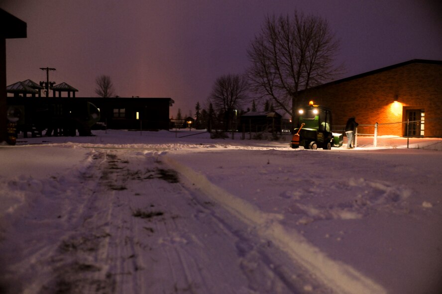 Dustin Moen, a landscaping contractor opens a gate while clearing snow at Minot Air Force Base, N.D. Dec. 3. Moen, a Minneapolis native, has been working at the base for more than a year clearing snow during the winter months. (U.S. Air Force photo/Senior Airman Stephanie Sauberan)