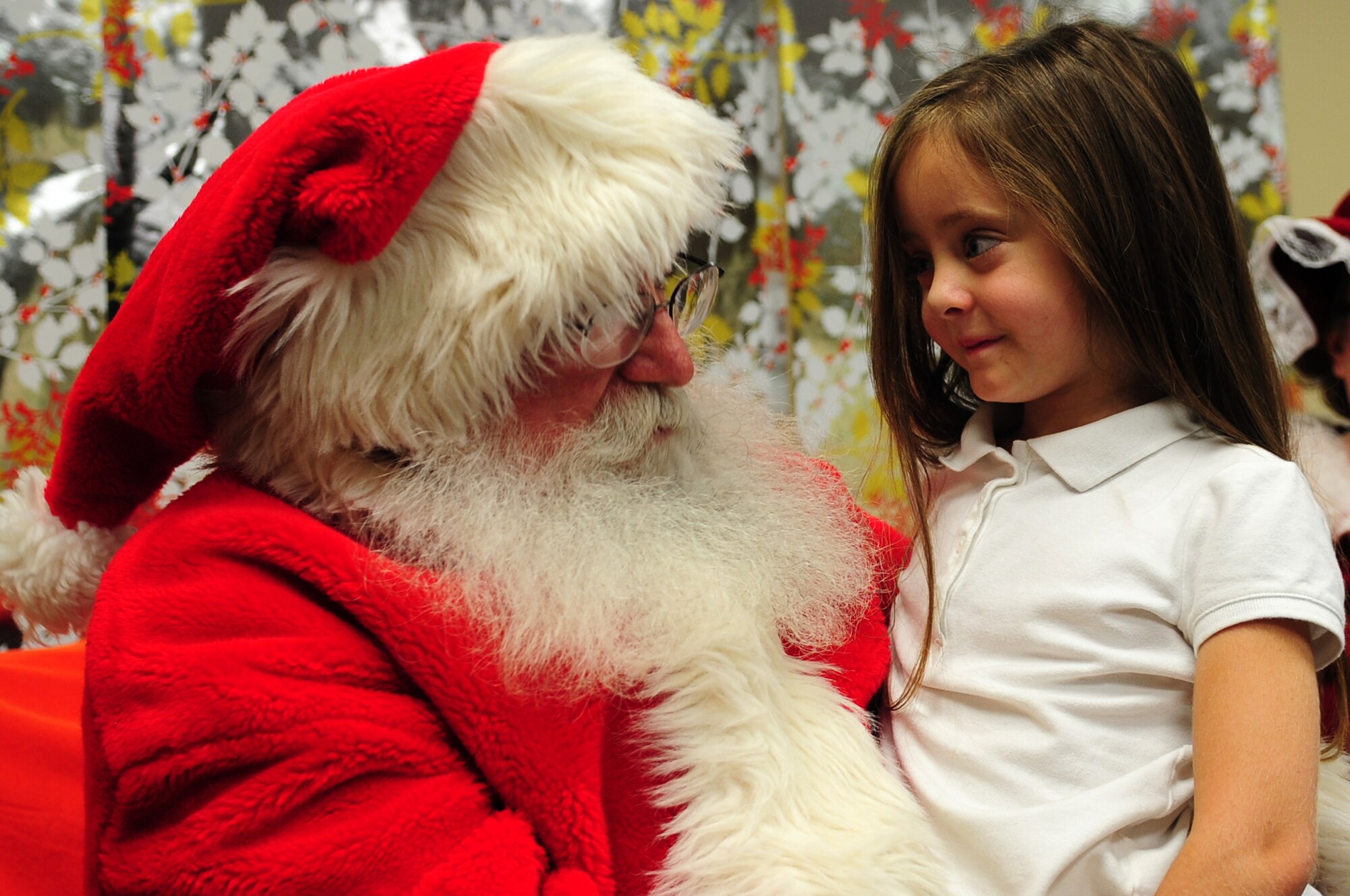 Madison Gallant, daughter of U.S. Air Force Master Sgt. Erine Gallant, 633rd Medical Group Aerospace Medical Service functional manager, speaks to Santa Claus during the Exceptional Family Member Program's meet and greet at the Airman and Family Readiness Center at Langley Air Force Base, Va., Dec. 6, 2013. During the event, attendees enjoyed Christmas movies and cookies. Gallant’s family hails from Vancouver, Wash. (U.S. Air Force photo by Airman Areca T. Wilson/Released)