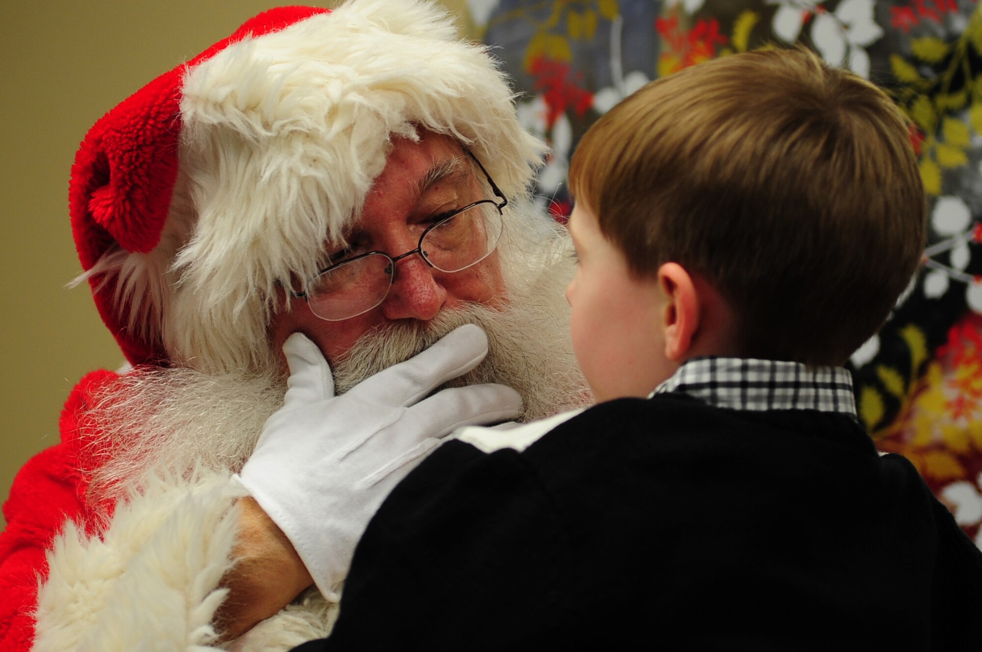 Jackson Cooper, son of U.S. Air Force Maj. Christopher Cooper, Air Combat Command Headquarters Directorate of Plans, Programs and Requirements chief of command and control, meets Santa Claus during the Exceptional Family Member Program's meet and greet at the Airman and Family Readiness Center at Langley Air Force Base, Va., Dec. 6, 2013. The event offered children the opportunity to be photographed with Santa. Jackson and his family hail from Yorktown, Va. (U.S. Air Force photo by Airman Areca T. Wilson/Released)