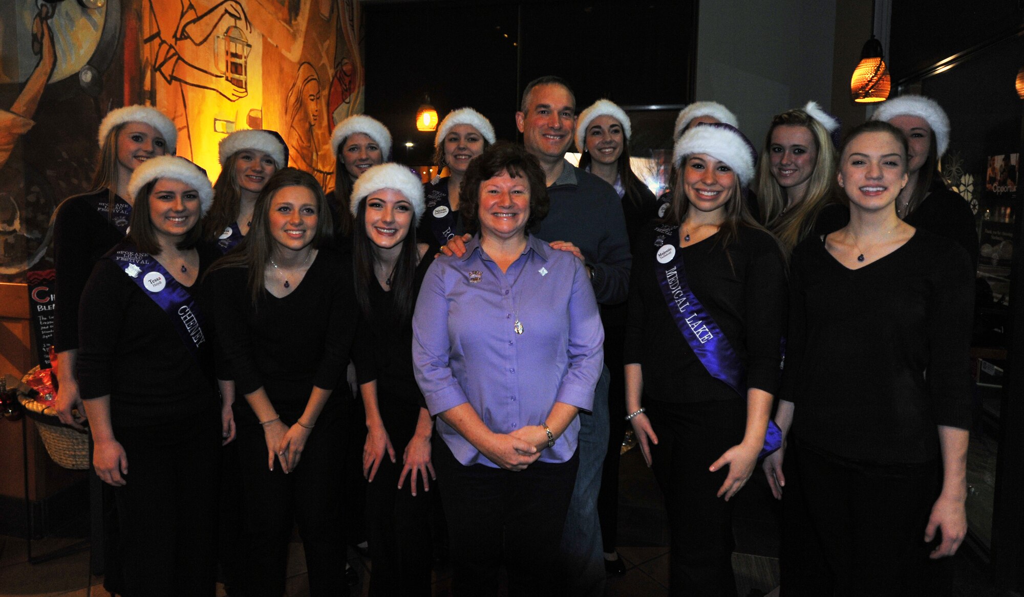 Col. Brian Newberry, 92nd Air Refueling Wing commander, stands with the Spokane Lilac Princesses before the cookie drive Dec. 9, 2013, at Airway Heights, Wash. The cookie drive is an annual event hosted by the Officer’s Spouses Club where the Lilac Princesses help sort and fill cookie bags. (U.S. Air Force photo by Staff Sgt. Veronica Montes/Released)