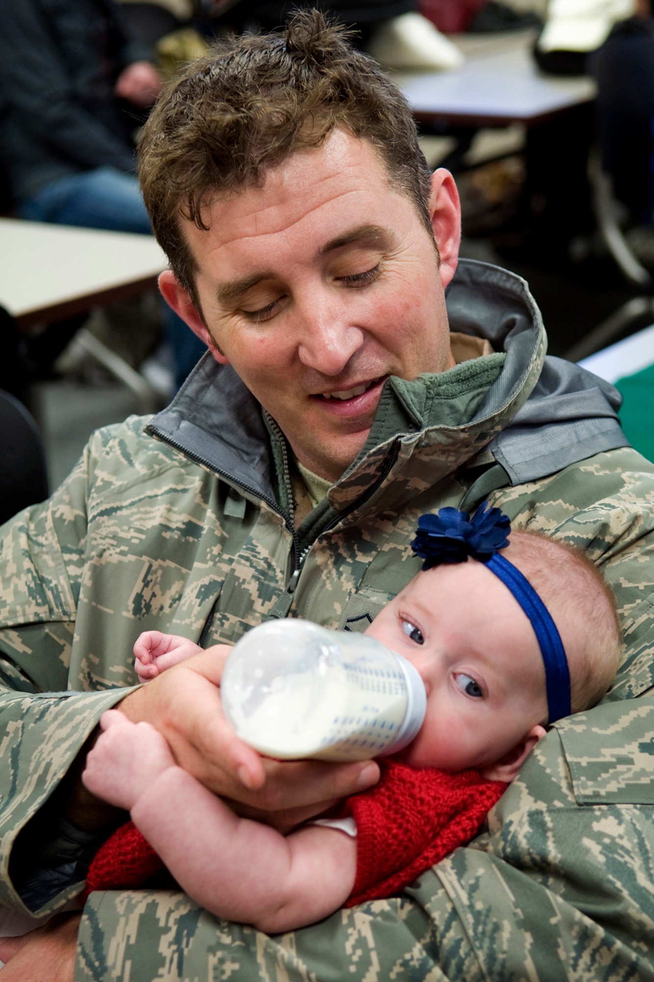 Master Sgt. Michael Morgan, 72nd Air Refueling Squadron inflight refueling evaluator, holds his 4-month-old daughter, Eila, after returning with nearly 40 other 434th Air Refueling Wing Airmen to Grissom Air Reserve Base, Ind., from a deployment to Southwest Asia Nov. 18, 2013. Eila was born shortly before her father deployed. (U.S. Air Force photo/Tech. Sgt. Mark R. W. Orders-Woempner)
