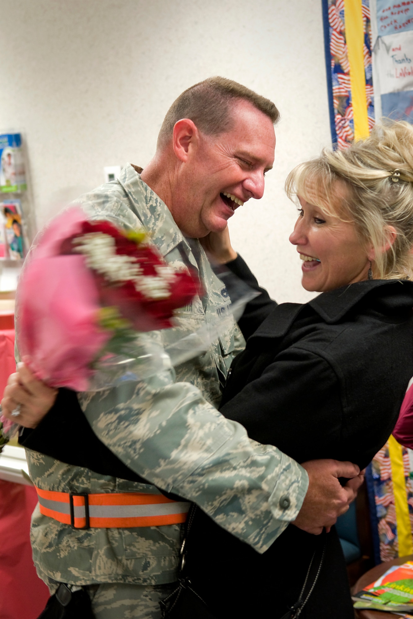 Russell W. Smith II, 434th Aircraft Maintenance Squadron integrated avionics systems specialist, is surprised by his girlfriend, Anita Hollis, in the Airman and Family Readiness Center at Grissom Air Reserve Base, Nov. 18, 2013. The unexpected reunion almost didn't happen as Smith never came through the center, where the families and friends had gathered, but Grissom personnel were able to use a bit of subterfuge and convince him to return and be greeted by his awaiting guest. (U.S. Air Force photo/Tech. Sgt. Mark R. W. Orders-Woempner)
