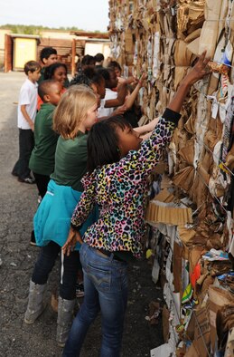 Students from Springfield Elementary School touch bundles of bound cardboard during a visit to Tyndall Dec. 5 at the Recycling Center on base. This was part of a 325th Civil Engineer Squadron program that teaches environmental information to local schools. (U.S. Air Force photo by Airman 1st Class Alex Echols)