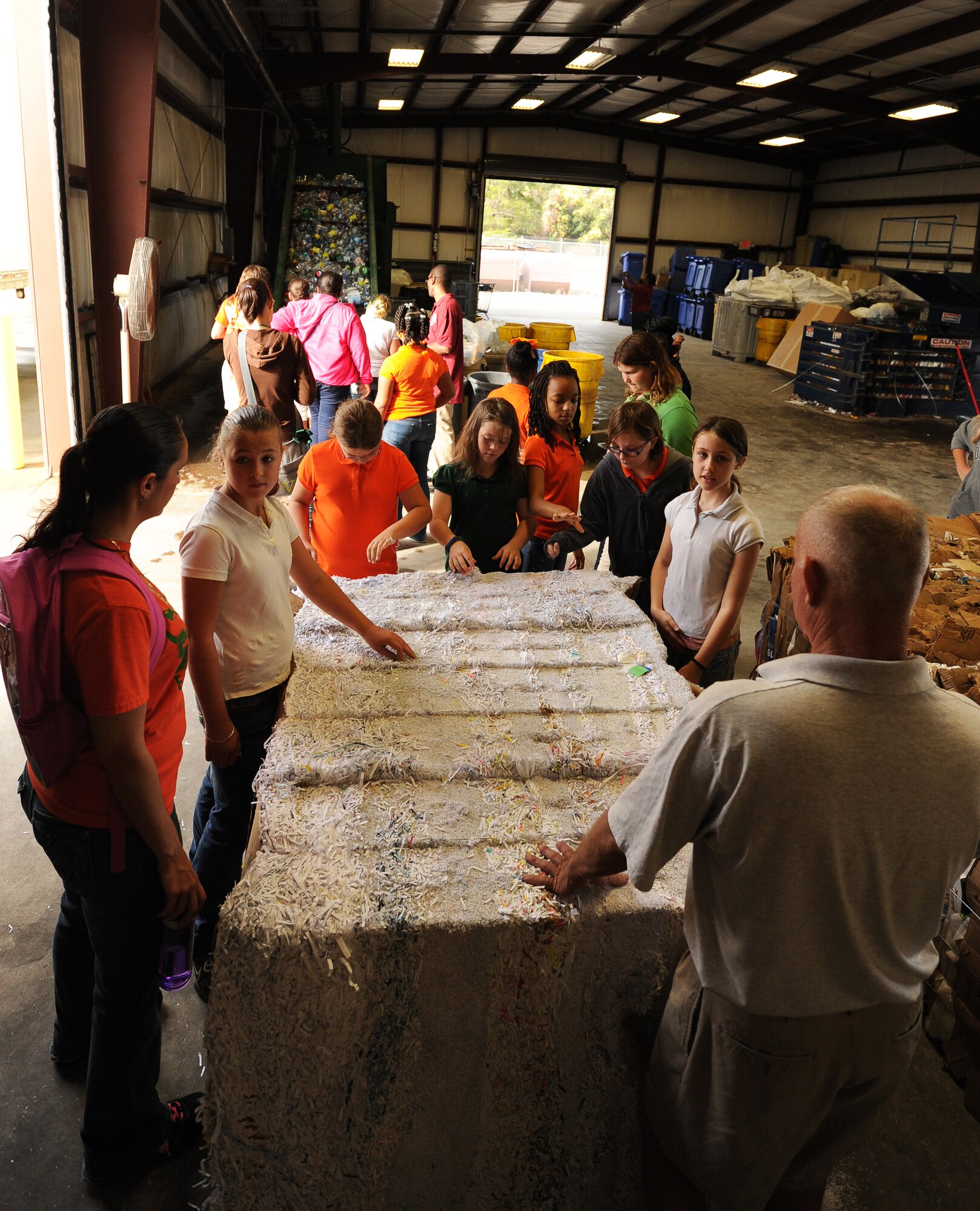 Students from Springfield Elementary School examine a compressed block of shredded paper during a visit to Tyndall Dec. 5 at the Recycling Center on base. This was part of a 325th Civil Engineer Squadron program that teaches environmental information to local schools. (U.S. Air Force photo by Airman 1st Class Alex Echols)