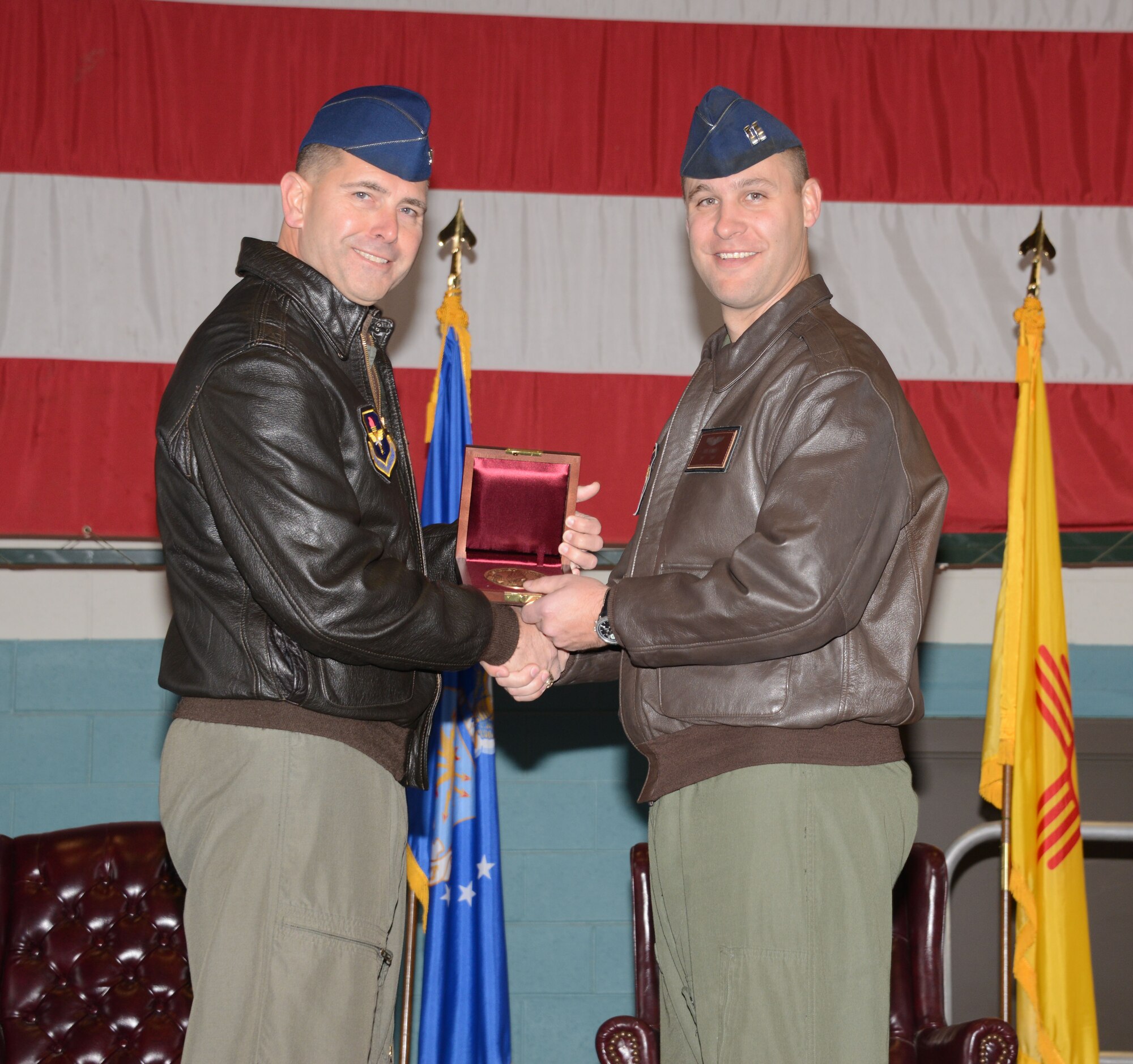 Col. Vincent Becklund (left), 58th Special Operations Wing commander, presents the Cheney Award to Capt. Thad Ronnau, an HH-60G helicopter instructor pilot in the wing. Ronnau was selected for the award for helping recover a battlefield wounded Soldier while deployed to Kandahar Airfield, Afghanistan. (Photo by Dennis Carlson)