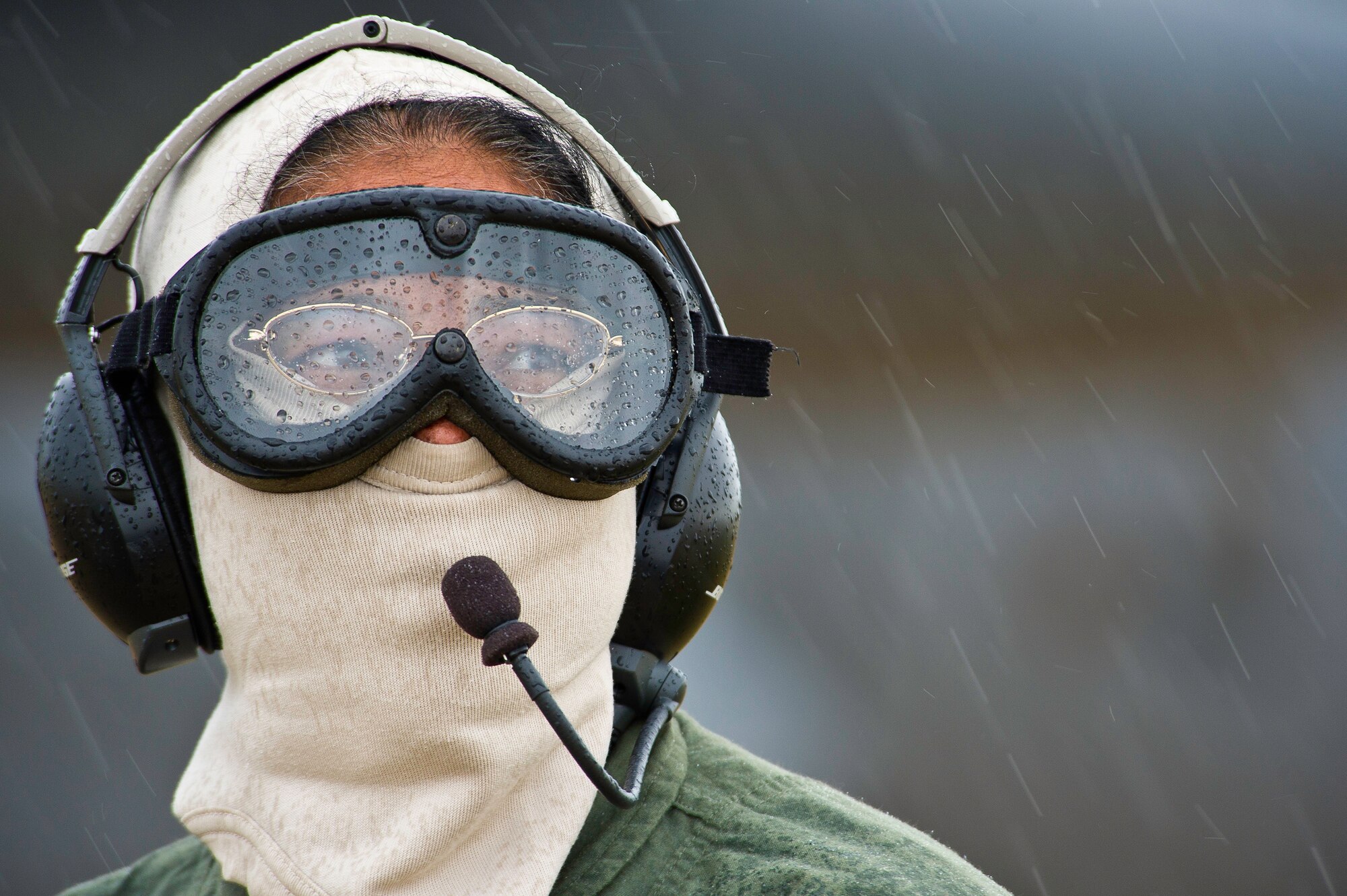 U.S. Air Force Capt. Tracy Tucker, a flight nurse with the 433rd Aeromedical Evacuation Squadron, Joint Base San Antonio-Lackland, Texas, works in the rain as a safety spotter during Warrior Exercise 86-13-01 (WAREX)/Exercise Global Medic, 2013, at Fort McCoy, Wis. July 27, 2013. The WAREX provides units an opportunity to rehearse military maneuvers and tactics. Held in conjunction with WAREX, Global Medic is an annual joint-field training exercise designed to replicate all aspects of theater combat medical support. (U.S. Air Force photo/Tech. Sgt. Efren Lopez)