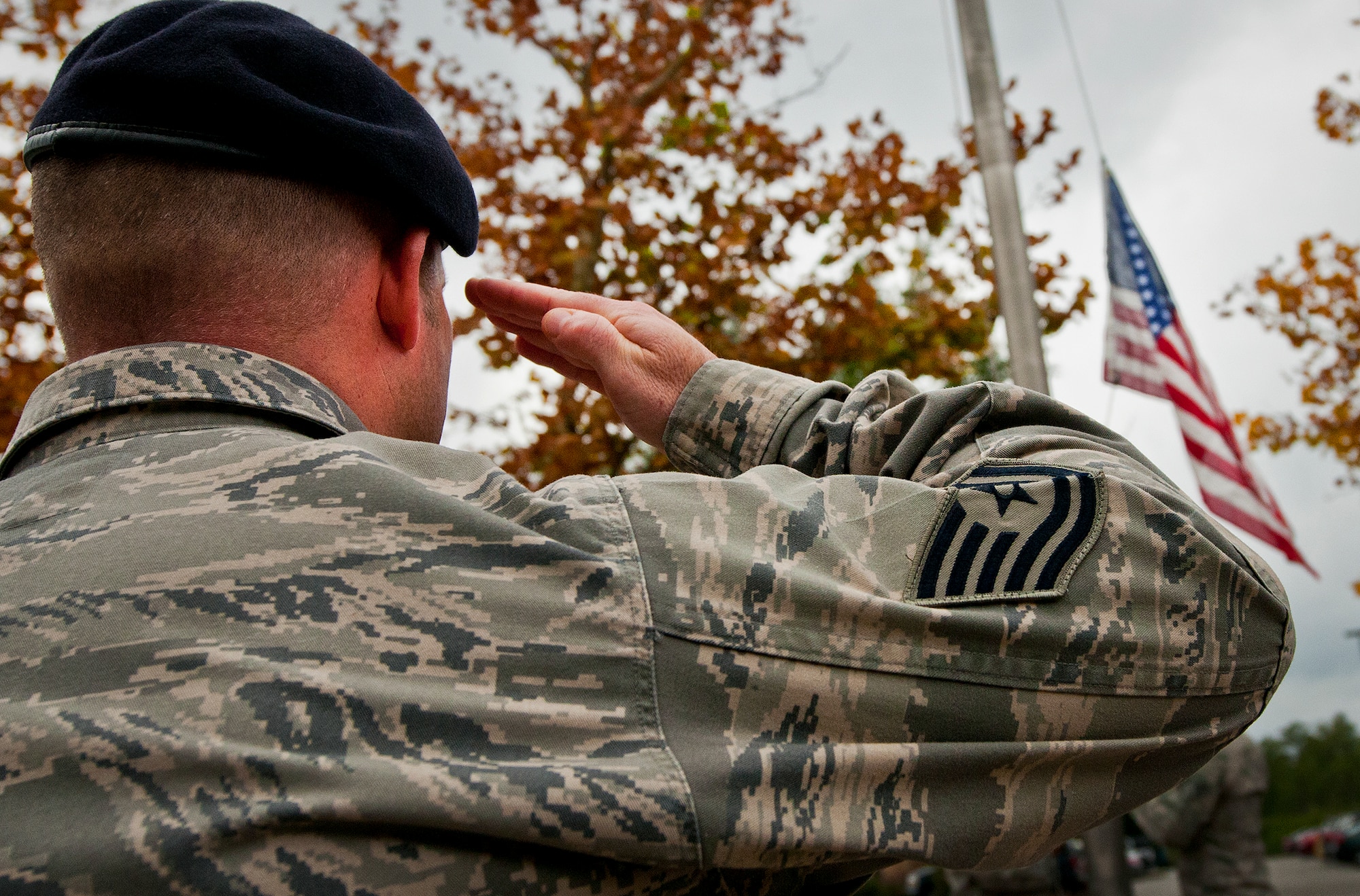 Tech. Sgt. Bryan Poole salutes as the American Flag is brought down in front of the 919th Special Operations Wing headquarters building at Duke Field, Fla., Dec. 6.  Poole and other 919th Security Forces Squadron members fulfilled a request from a retiring former 919th SOW member to have a flag flown at the base.  The flag was flown above the headquarters building for a few seconds while security forces members saluted before being brought down and folded for presentation.  (U.S. Air Force photo/Tech. Sgt. Sam King)