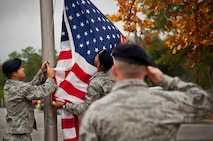 Tech. Sgt. Bryan Poole salutes as the American Flag is lifted up in front of the 919th Special Operations Wing headquarters building at Duke Field, Fla., Dec. 6.  Poole and other 919th Security Forces Squadron members fulfilled a request from a retiring former 919th SOW member to have a flag flown at the base.  The flag was flown above the headquarters building for a few seconds while security forces members saluted before being brought down and folded for presentation.  (U.S. Air Force photo/Tech. Sgt. Sam King)