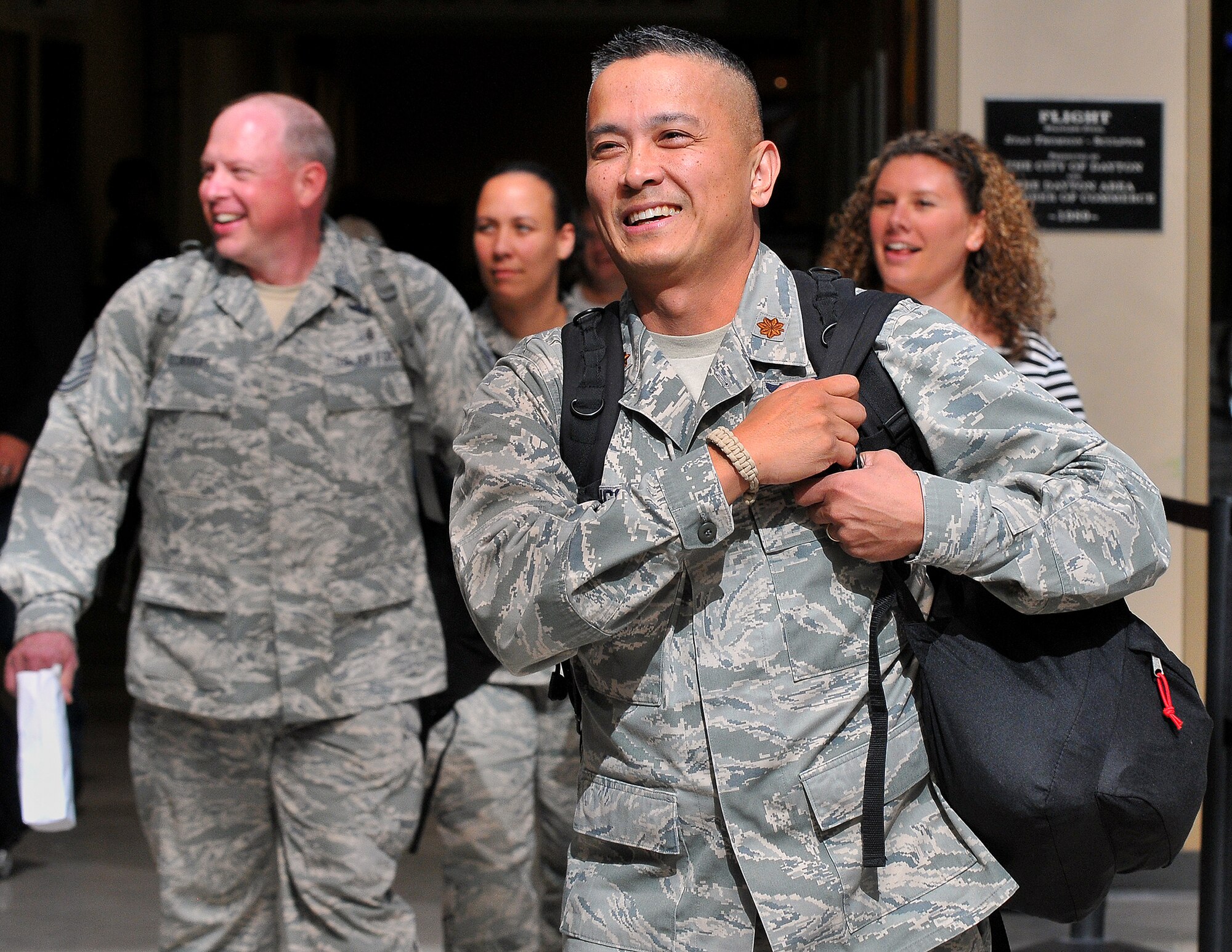 WRIGHT-PATTERSON AIR FORCE BASE, Ohio – Maj. Romeo Cabungcal, 445th Aeromedical Evacuation Squadron flight nurse along with Master Sgts. Brad Eckhart and Carie Brown, also assigned to the 445 AES, arrive at the at Dayton International Airport upon their return from a six-month deployment Sept. 26, 2013. The trio was part of medical evacuation teams flying patients from downrange, to Germany and the United States. (U.S. Air Force photo/Tech. Sgt. Frank Oliver) 