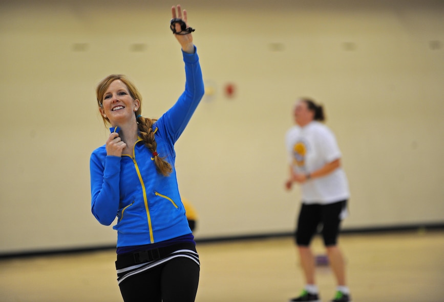 Jennifer Jens, personal trainer and fitness instructor at the McAdoo Sports and Fitness Center, leads Airmen and dependants in physical fitness exercises as part her Fit to Fight class, Dec. 6. The class encompasses various strength, core and cardio routines. Jens instructs various physical fitness classes at the base fitness center. (U.S. Air Force photo/Senior Airman Jose L. Hernandez)