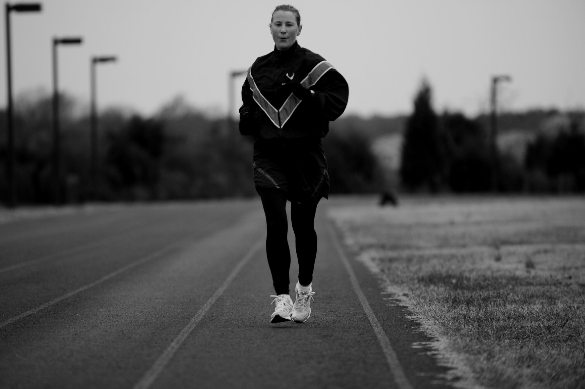 U.S. Air Force Maj. Carrie Wentzel, 633rd Force Support Squadron operations officer, finishes lap 16 of a five-mile run on the outdoor track at Langley Air Force Base, Va., Nov. 26, 2013. Throughout her Air Force career, Wentzell has competed in distance races across the world. (U.S. Air Force photo by Staff Sgt. Jarad A. Denton/Released)