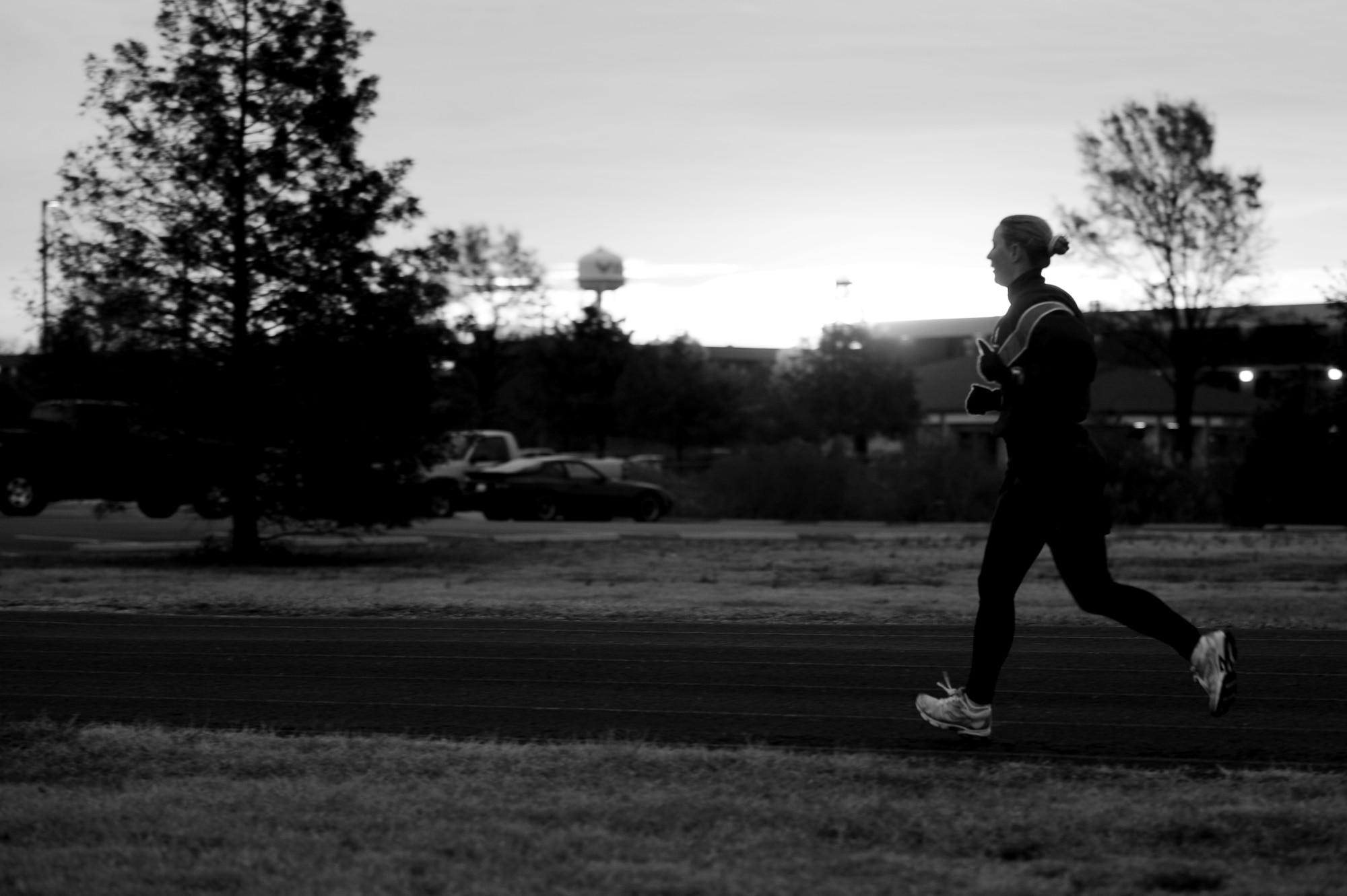U.S. Air Force Maj. Carrie Wentzel, 633rd Force Support Squadron operations officer, runs through a curve on the outdoor track at Langley Air Force Base, Va., Nov. 26, 2013. Wentzell, a seasoned marathon runner, is training for the Langley 10-mile “Race ‘Round the Base,” scheduled for Dec. 14. (U.S. Air Force photo by Staff Sgt. Jarad A. Denton/Released)