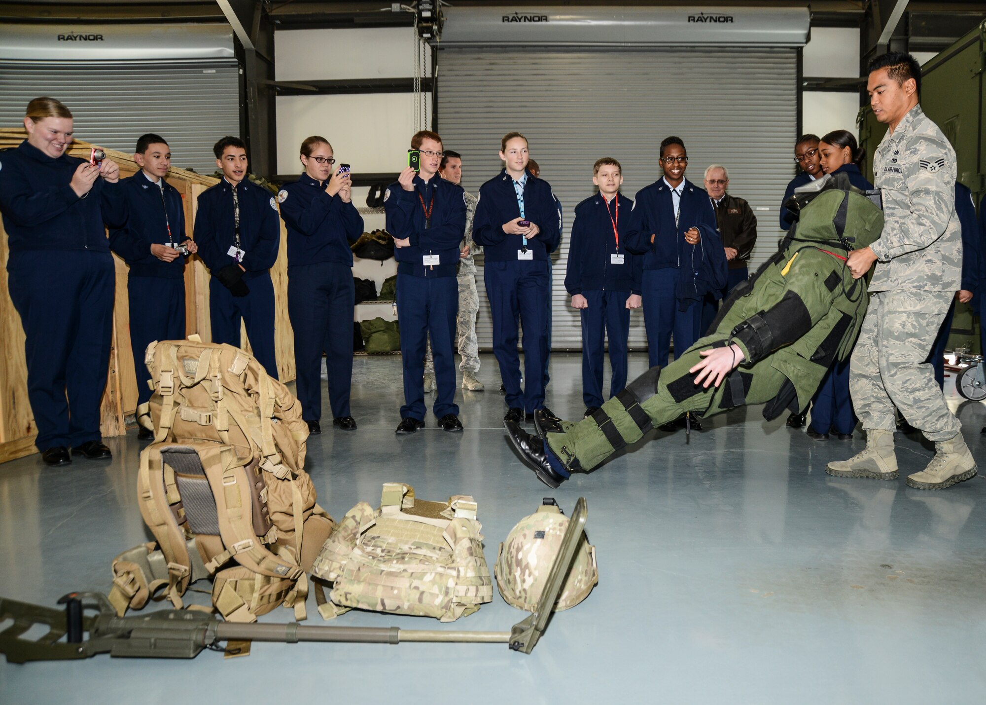 Senior Airman Adrian Salapare demonstrates the true weight of the bomb suit by laying the student on their back and letting them figure out how to get back on their feet. (U.S. Air Force photo by Rebecca Amber)