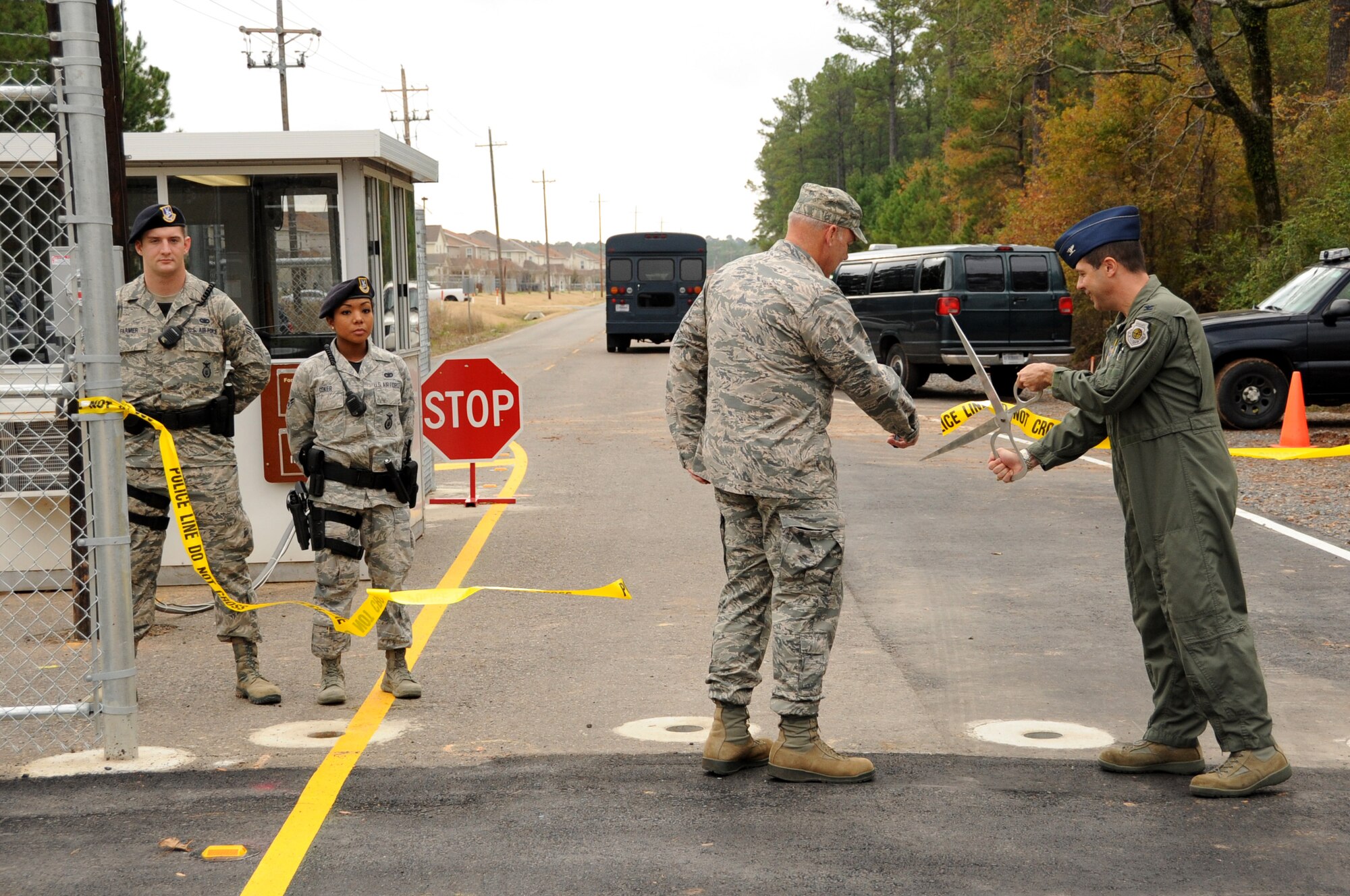 Tech. Sgt. Cedric Colón, 26th Operational Weather Squadron, presents his common access card to Airman 1st Class Mercedes Coker, 2nd Security Forces Squadron defender on Barksdale Air Force Base, La., Dec. 2, 2013. Colón and his family have lived on the East Reservation for more than six years and were the first to use the Bodcau Gate after its official opening ceremony. (U.S. Air Force photo/Staff Sgt. Katherine Holt)