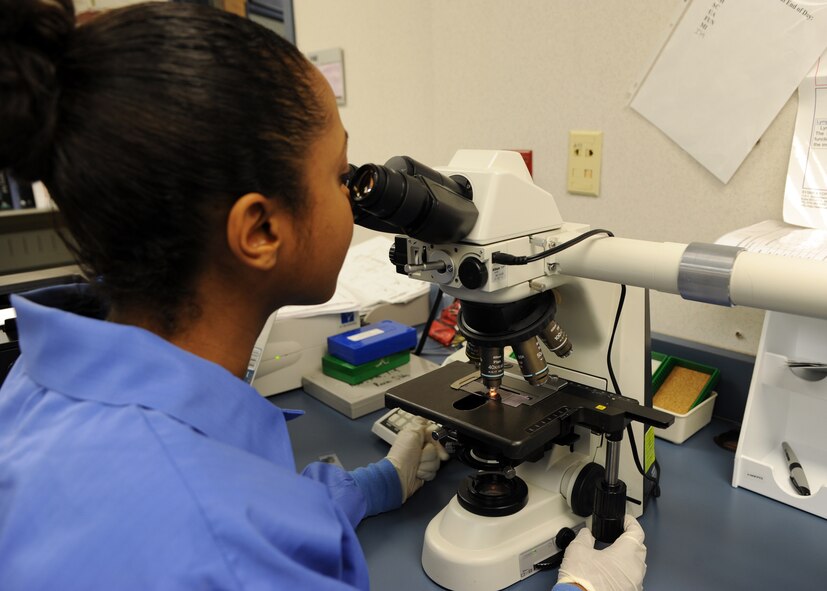 Desireé Gladney, 2nd Medical Group lab technician, looks through a light-field microscope at the 2nd MDG clinic on Barksdale Air Force Base, La., Dec. 4, 2013. Gladney performed a differential blood smear on the light-field microscope to determine if the patient has sickle cell anemia. (U.S. Air Force photo/Senior Airman Joseph A. Pagán Jr.)