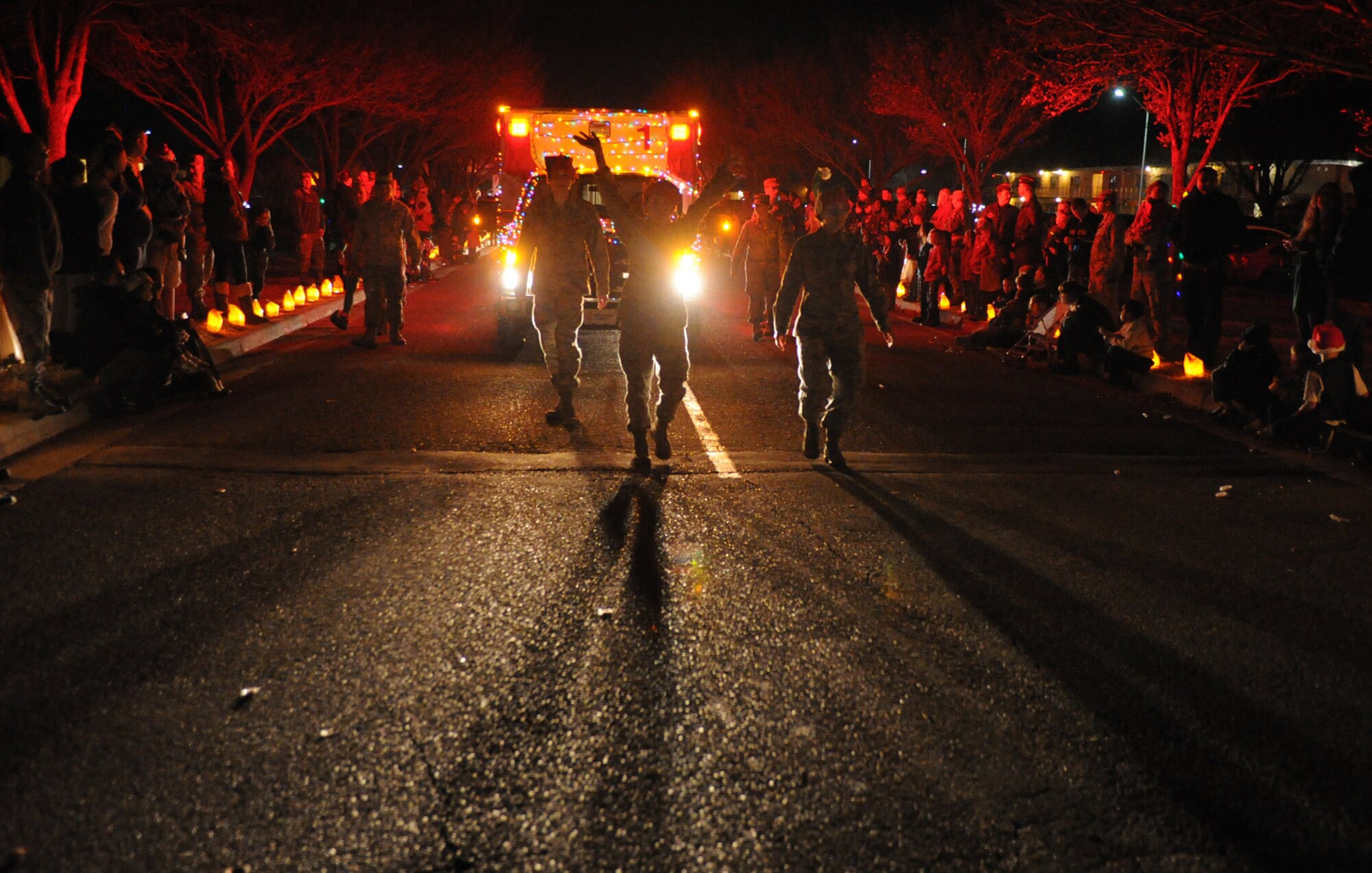 A crowd gathers to watch the holiday parade Dec. 4, 2013, at Cannon Air Force Base, N.M. The parade included floats decorated by the squadrons and an appearance by Santa Claus himself. (U.S. Air Force photo/Senior Airman Ericka Engblom)