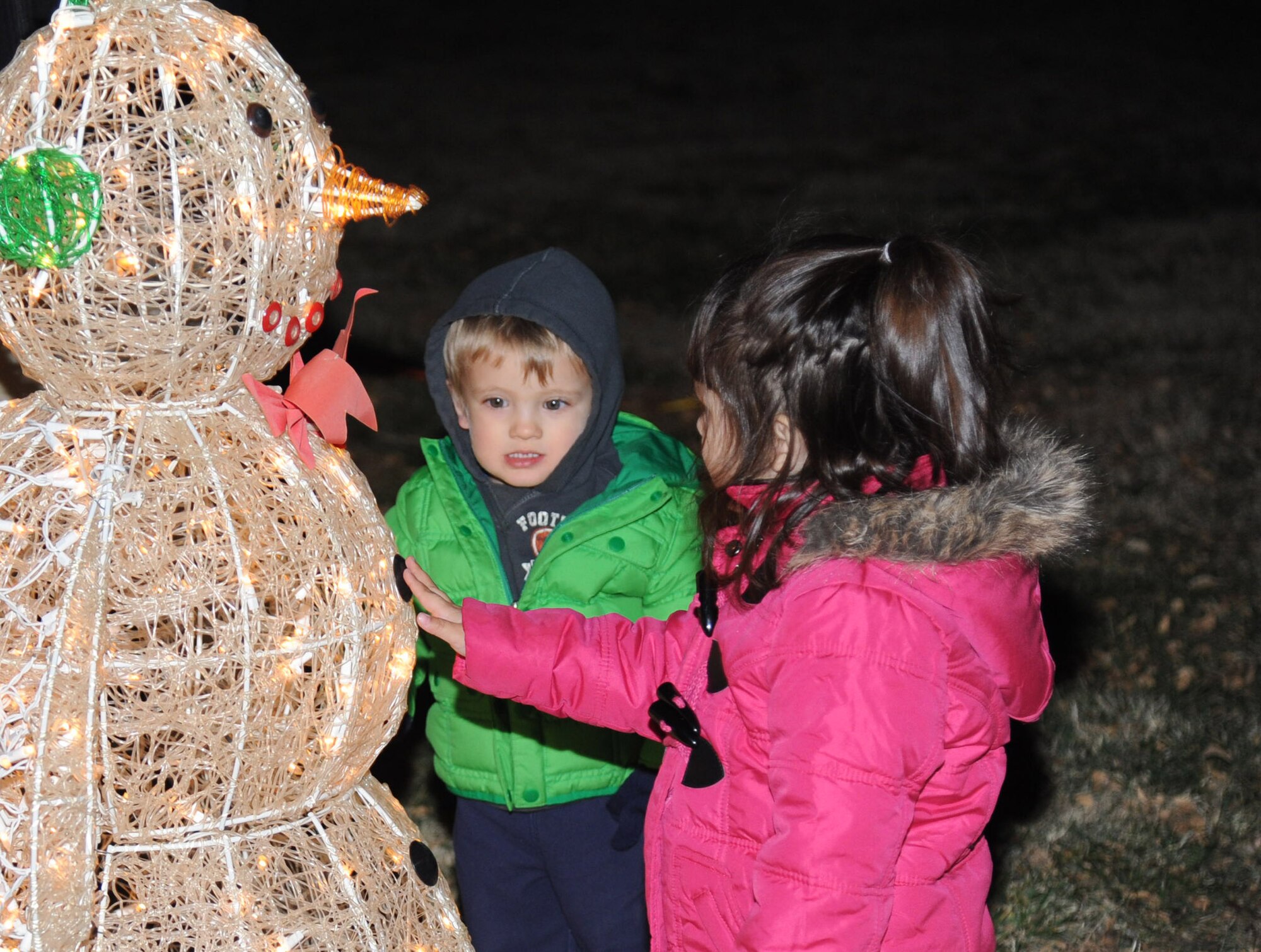 Children admire the lights before the beginning of the holiday parade Dec. 4, 2013, at Cannon Air Force Base, N.M. The parade included floats decorated by the squadrons and an appearance by Santa Claus himself. (U.S. Air Force photo/Airman 1st Class Chip Slack)