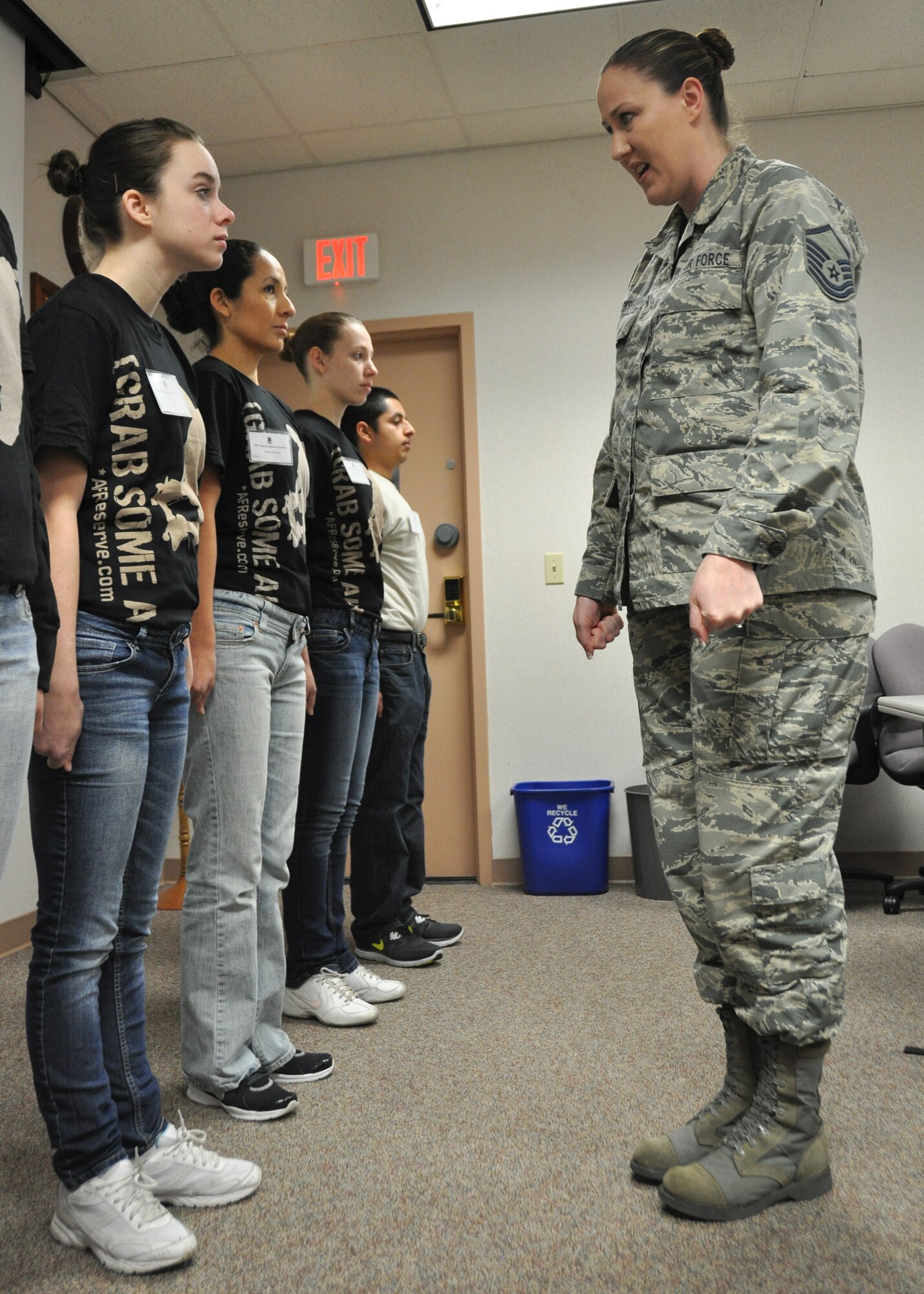 Master Sgt. Veronica Rooks, Development and Training Flight Program Manager, explains the proper hand positions for the position of attention to Trainee Evelyn Synak. DTF's purpose prepares Reserve trainees mentally and physically for basic training. (U.S. Air Force photo/Tech Sgt. Heather Skinkle)