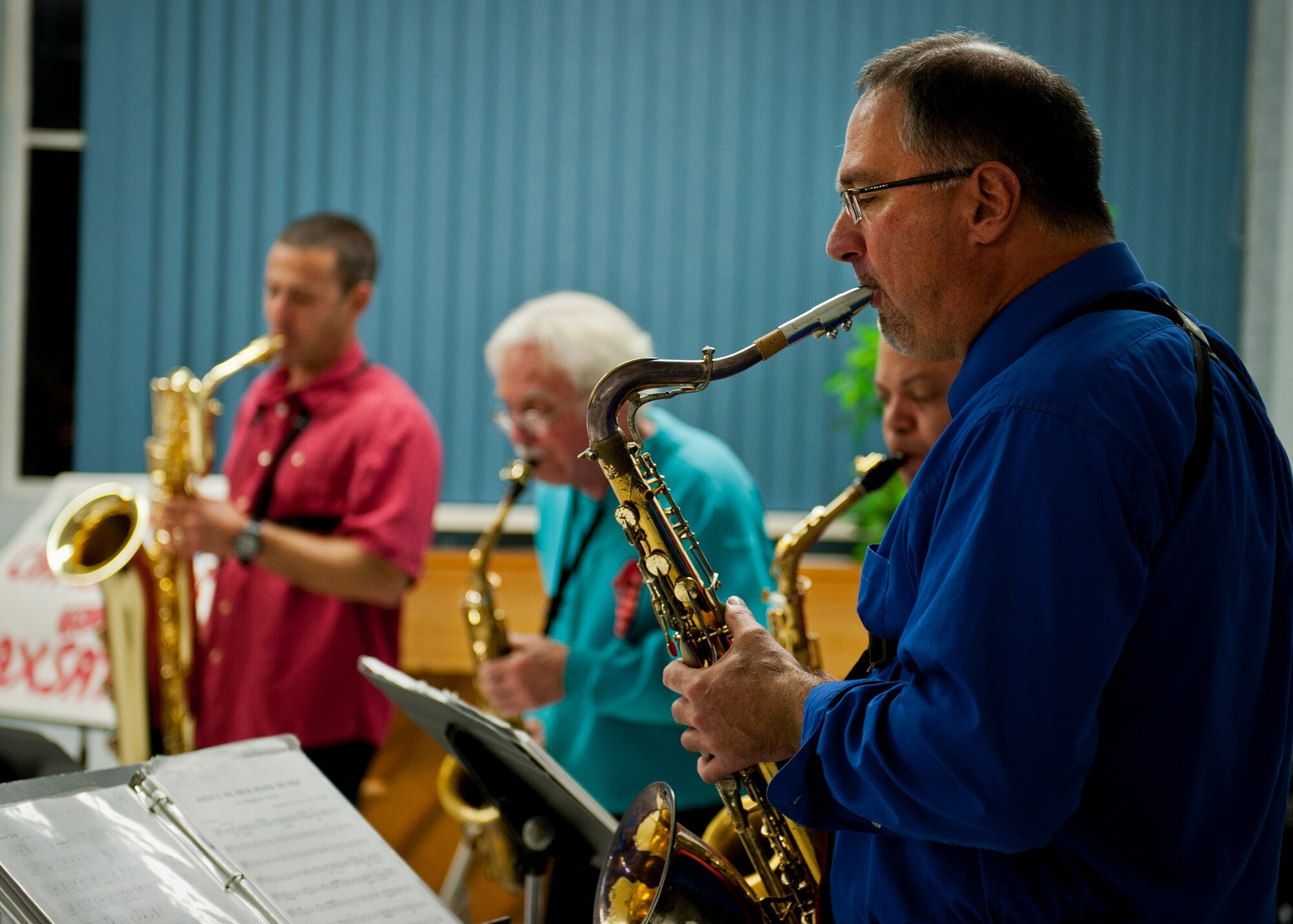 The Saxsations led by Dennis Rackard provide musical entertainment during the reception at Team Eglin's annual Christmas tree lighting ceremony at the West Gate Chapel Dec. 6. Chaplains and senior leadership led the event with messages of unity and awards for the base-wide, life-sized card decoration contest. Following the lighting of the tree, Santa arrived by fire truck to meet with the children and hear their Christmas wishes. (U.S. Air Force photo/Sara Vidoni)