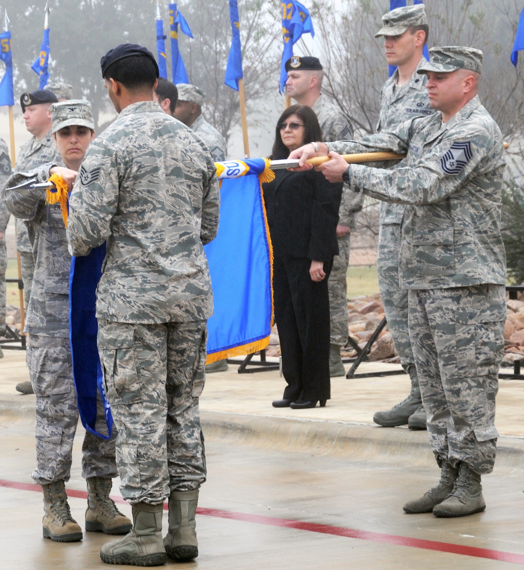 Col. Christine Erlewine cases the 902nd Mission Support Group colors for inactivation during the 502nd Air Base Wing transformation ceremony at Joint Base San Antonio-Fort Sam Houston Dec. 4. The 902nd MSG, which Erlewhine was the commander of, was redesignated as the 502nd Security Forces and Logistics Support Group at JBSA-Randolph. (U.S. Air Force photo by Steve Elliott)