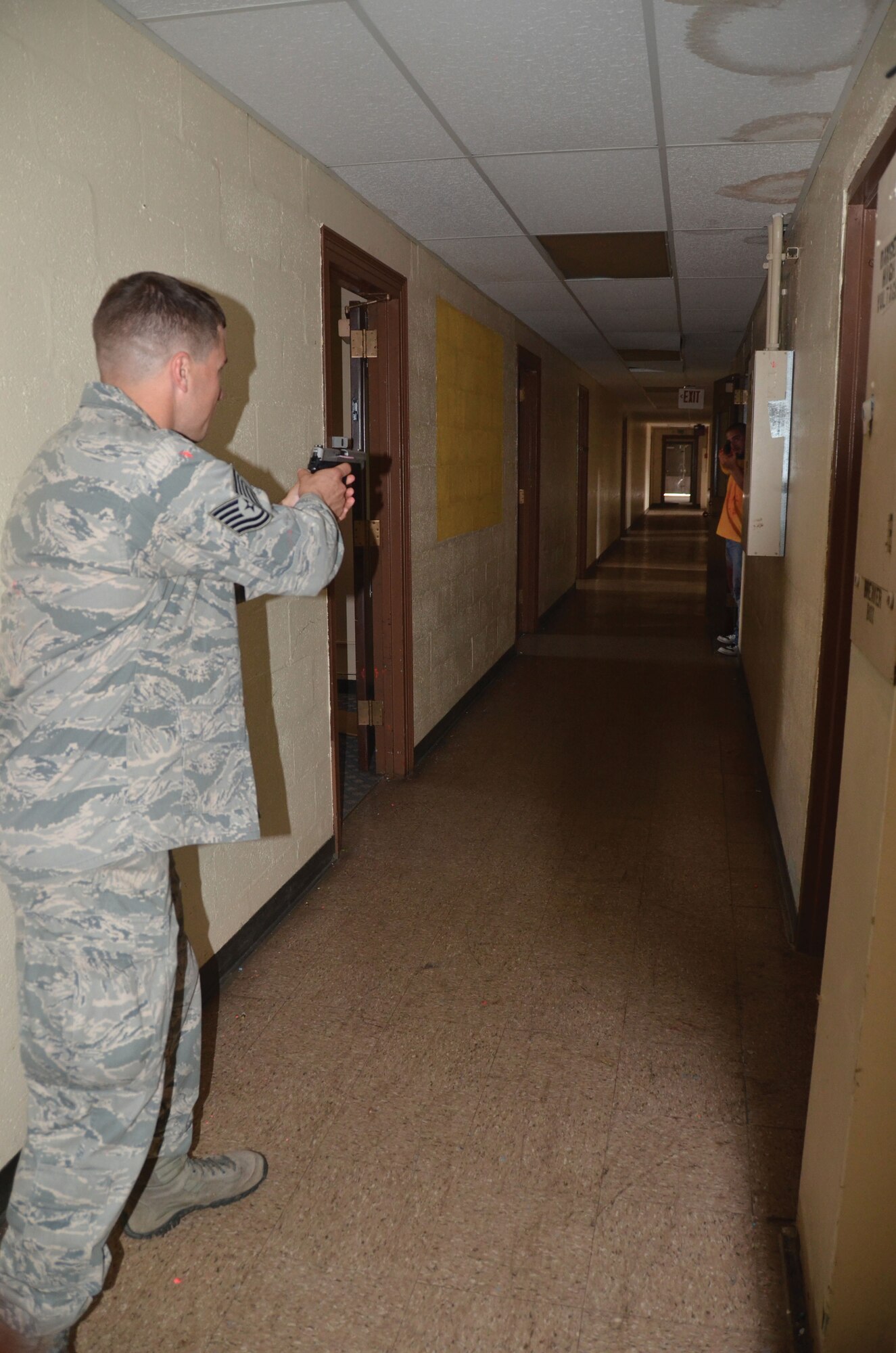 WRIGHT-PATTERSON AIR FORCE BASE, Ohio - Tech. Sgt. Ryan Lause draws his weapon as he asks the "gunman" to surrender during an active shooter scenario July 11.  Four 445th Security Forces Squadron reservists participated in a multi-agency Solo Engagement Training at the former Marine Corps Reserve training and administrative center located in Dayton, Ohio. The training was hosted by the Wright State University Police Department. (U.S. Air Force photo/Stacy Vaughn)