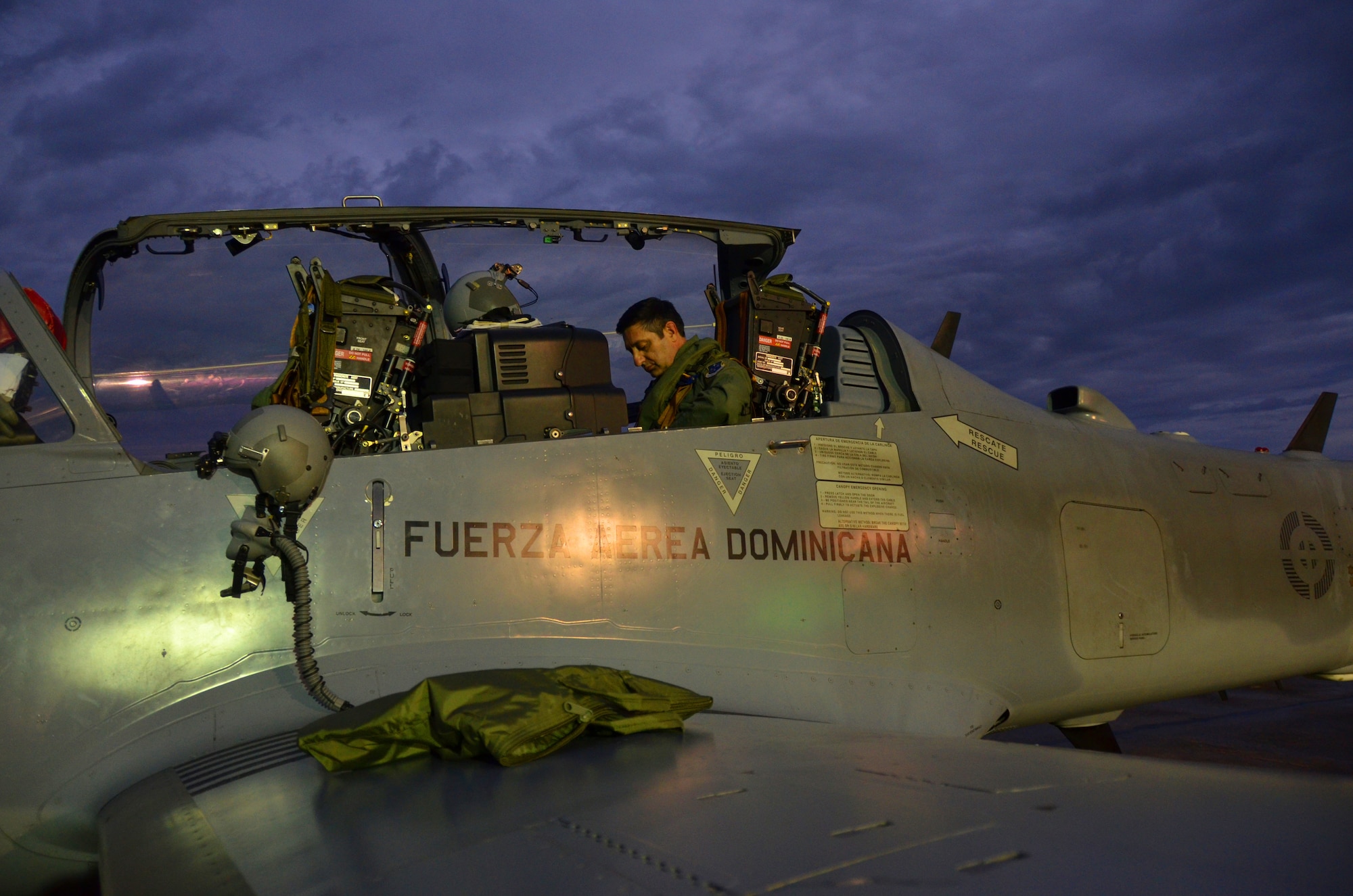 Col. Mike Torrealday, a U.S. Air Force F-16 instructor pilot, prepares for a nighttime flight in the back seat of a Dominican Republic air force A-29 Super Tucano as part of an exercise to combat illegal drug trafficking Dec. 4, 2013. The exercise is part of the Sovereign Skies Program, an initiative between the U.S., Colombian, and Dominican Republic air forces to share best-practices on procedures to detect, track and intercept illegal drugs moving north from South America. Since the program’s inception, the number of aircraft suspected to traffic drugs through the Dominican Republic dropped from more than 100 annually to nearly zero. (U.S. Air Force photo by Capt. Justin Brockhoff/Released)


