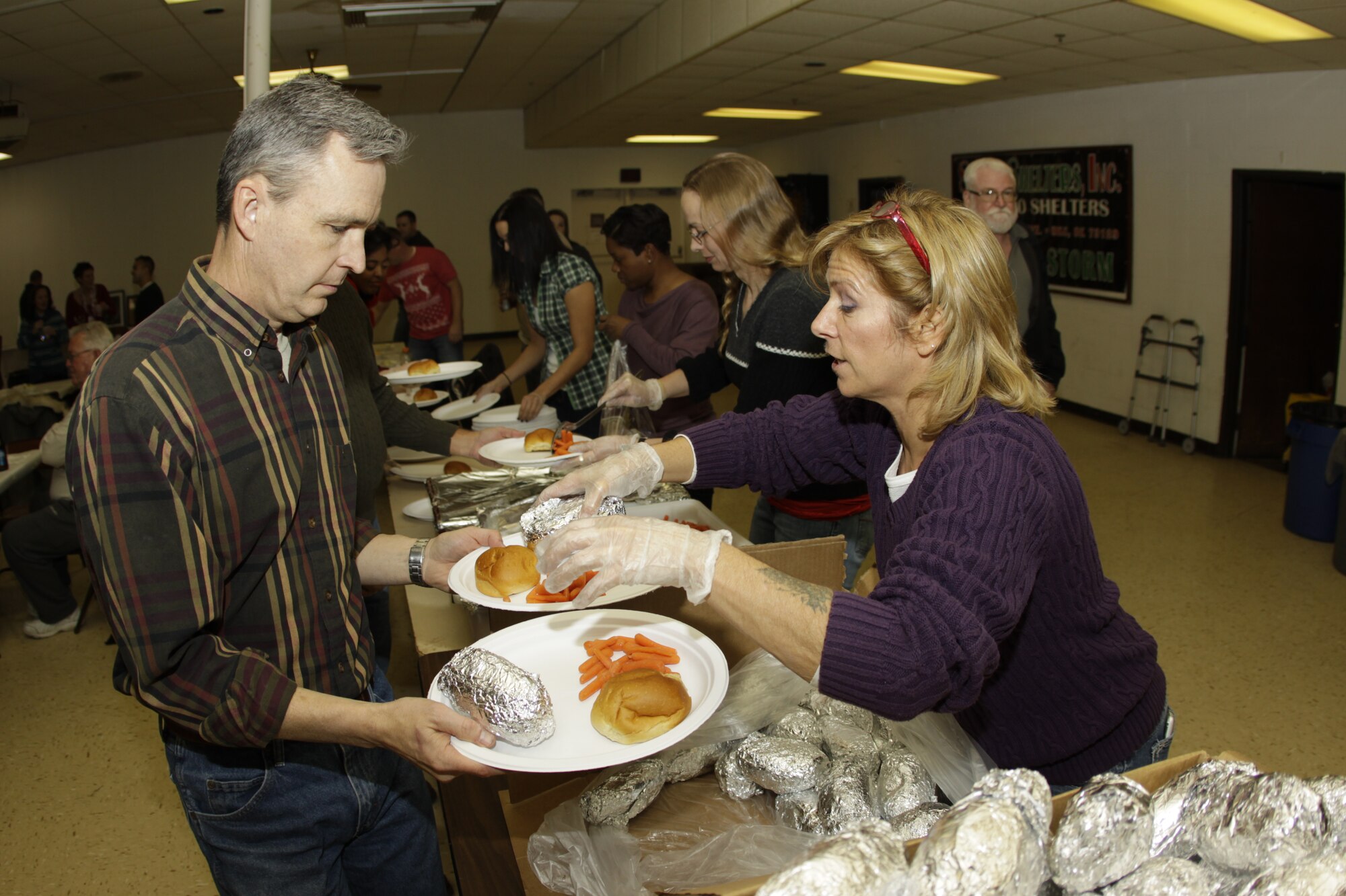 Acting 507th Air Refueling Wing Commander, Col. Kevin Trayer helps serve rib eye steaks during the Operation Holiday Spirit Steak Supper at the Del City American Legion Dec. 7.  The event raised a record-breaking $34,769 to support guard and reserve Airmen in need. (U.S. Air Force Photo/Staff Sgt. Caleb Wanzer) 