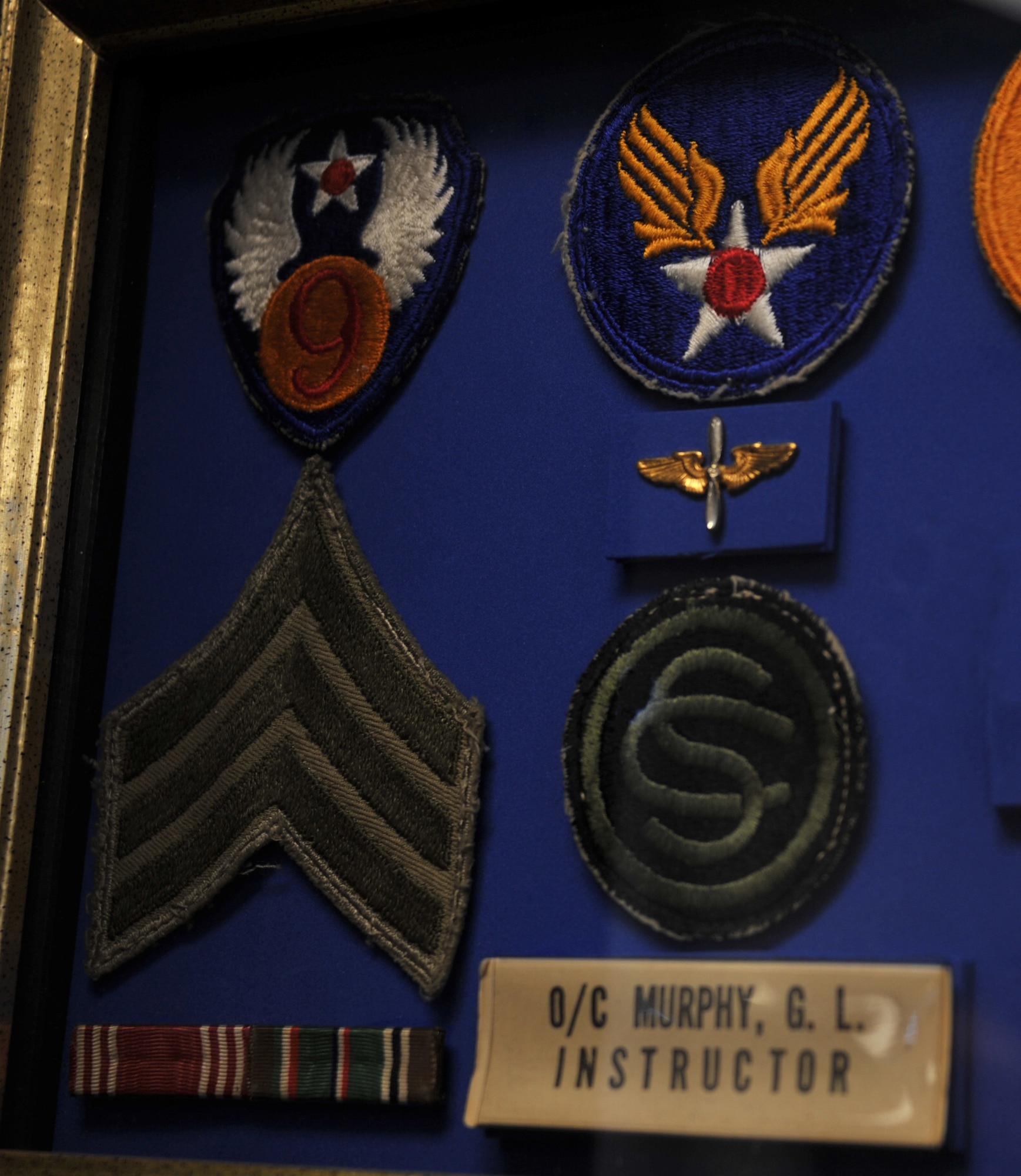 MAXWELL AIR FORCE BASE, Ala. – Dr. Bruce T. Murphy’s, Air University vice president of academic affairs, father’s military memorabilia sits displayed in Murphy’s office Nov. 8, 2013. Murphy, a U.S. Army Veteran, keeps this display along with his own military memorabilia in his office. The instructor pin is one of his most treasured pieces as it reminds him of the importance of military education. Murphy is retiring from his position at AU Dec. 31, 2013. His new job will be president of Nicholls State University in Thibodaux, La.  (U.S. Air Force photo by Staff Sgt. Natasha Stannard)