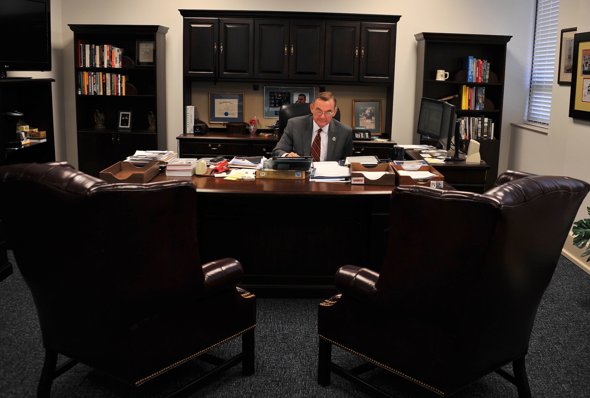 MAXWELL AIR FORCE BASE, Ala. -- Dr. Bruce T. Murphy goes through paper work at his desk Nov. 8, 2013. Murphy is retiring from his position as Air University’s vice president of academic affairs Dec. 31, 2013. He spent five years in the position, and is taking presidency of Nicholls State University in Thibodaux, La. (U.S. Air Force photo by Staff Sgt. Natasha Stannard)