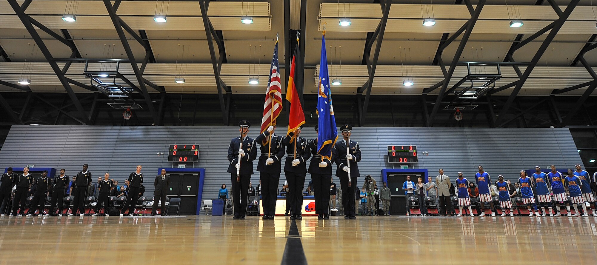 86th Force Support Squadron guardsman post the colors before the Harlem Globetrotters game, Dec. 5, 2013, Ramstein Air Base, Germany. Navy and Armed Forces Entertainment hosted a Harlem Globetrotters basketball game in support of the troops at the Southside Fitness Center. (U.S. Air Force photo/Airman Dymekre Allen)