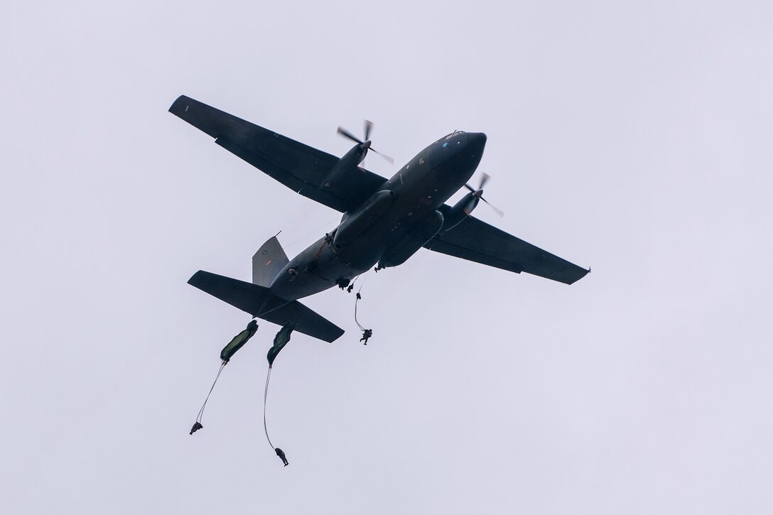 Paratroopers jump from a German Transall C-160 aircraft during the 16th Annual Randy Oler Memorial Operation Toy Drop on Sicily Drop Zone, Fort Bragg, N.C., Dec. 7, 2013.