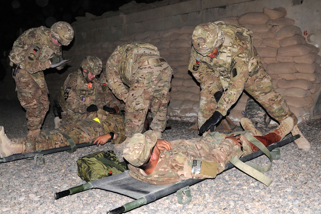 U.S. soldiers assist with simulated casualties during a mass casualty ...