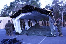 Sailors with 2nd Dental Battalion, 2nd Marine Logistics Group assemble a tent during an Authorized Dental Allowance List exercise aboard Camp Lejeune, N.C., Dec. 6, 2013. Once assembled, sailors disassembled the tent and participated in a walk-through instruction of expeditionary equipment and field exam procedures. (U.S. Marine Corps photo by Lance Cpl. Shawn Valosin)