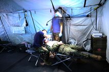 Sailors with 2nd Dental Battalion, 2nd Marine Logistics Group perform an oral examination in a field environment during an Authorized Dental Allowance List exercise aboard Camp Lejeune, N.C., Dec. 10, 2013. The ADAL EX provided service members an opportunity to sharpen their skills by forcing them to do more with less. (U.S. Marine Corps photo by Lance Cpl. Shawn Valosin)