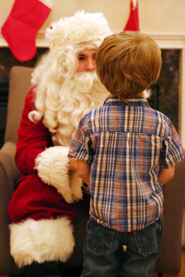 A little boy meets Santa during the EFMP holiday event at the Lincoln Military Housing main office Dec. 6, 2013. More than 100 people participated in the annual event. 