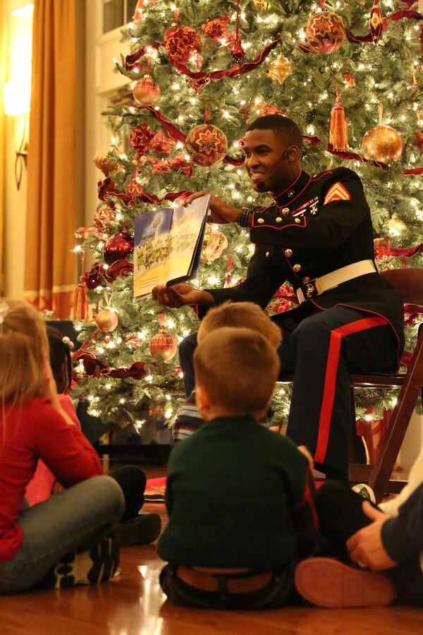 Cpl. Paris Capers, volunteer, reads a story during the EFMP holiday event at the Lincoln Military Housing main office Dec. 6, 2013. Many volunteers made the annual event a success
