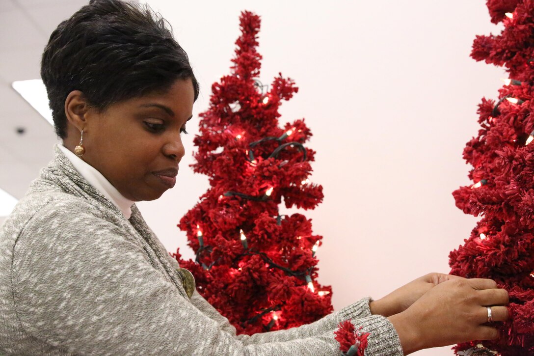 Tasha Spencer, Marine Corps Community Services retail director, hangs an ornament on a Christmas tree at the Marine Corps Exchange on Dec. 4, 2013. Spencer has worked in retail for 11 years. 